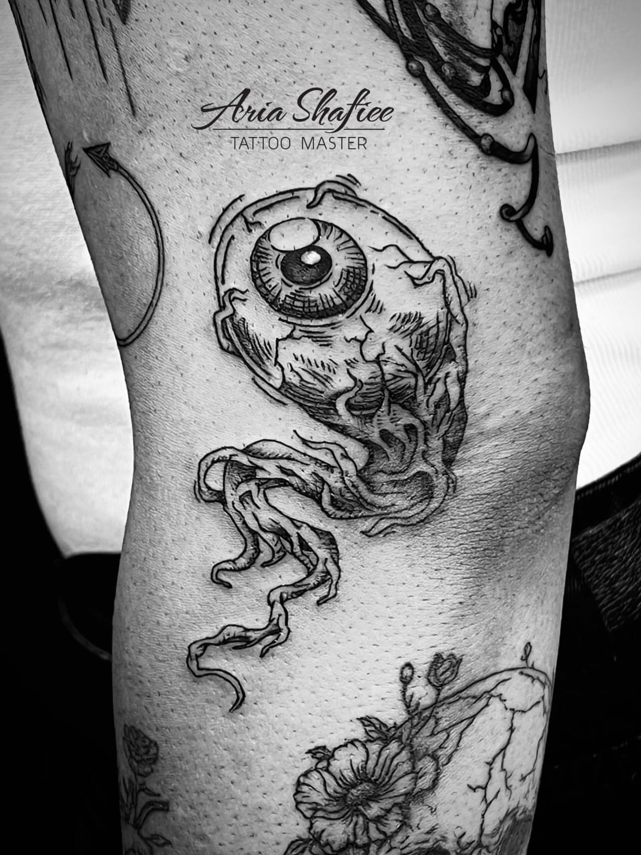 Eye and tentacles realism tattoo on the forearm by Aria Shafiee