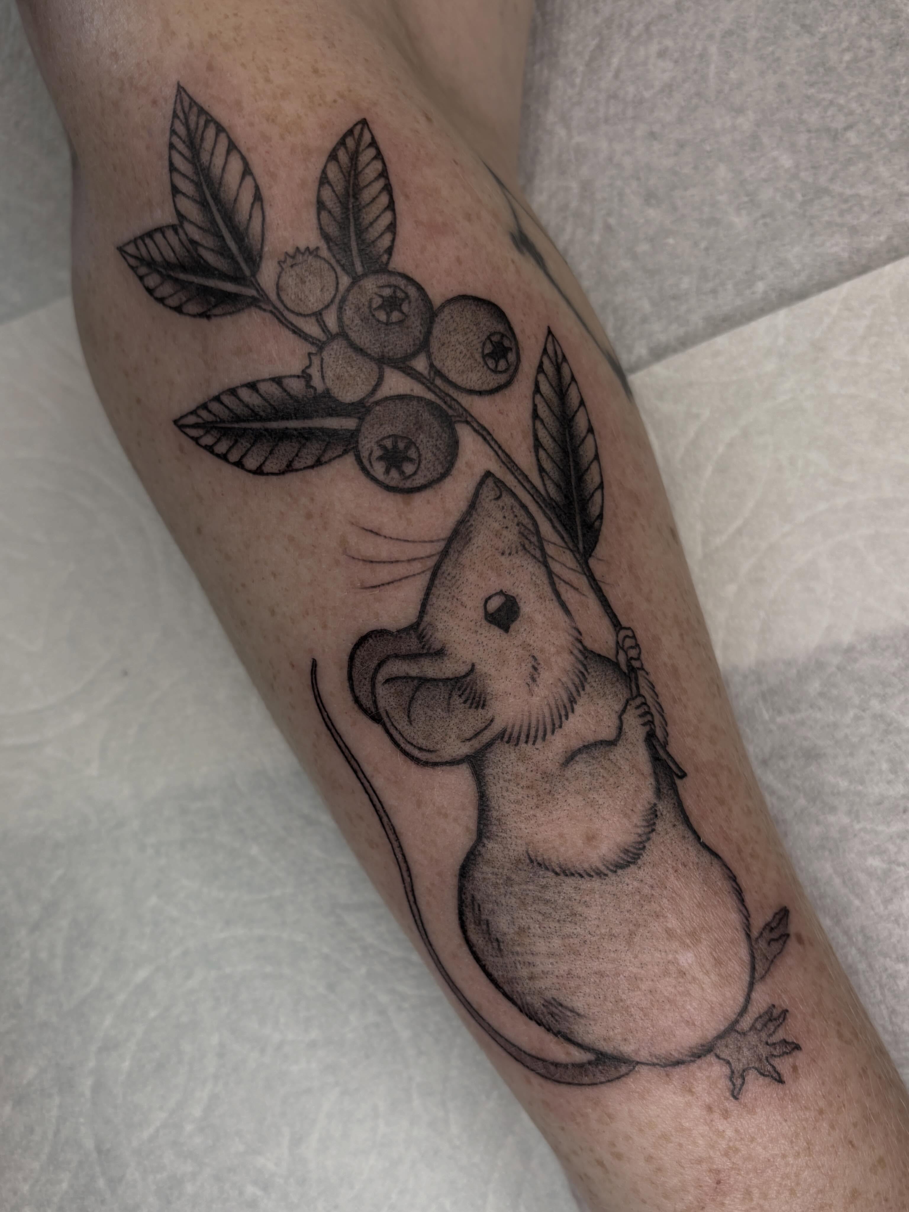 Mouse and berries black and grey tattoo on the forearm by Amelia Rose, Los Angeles, California