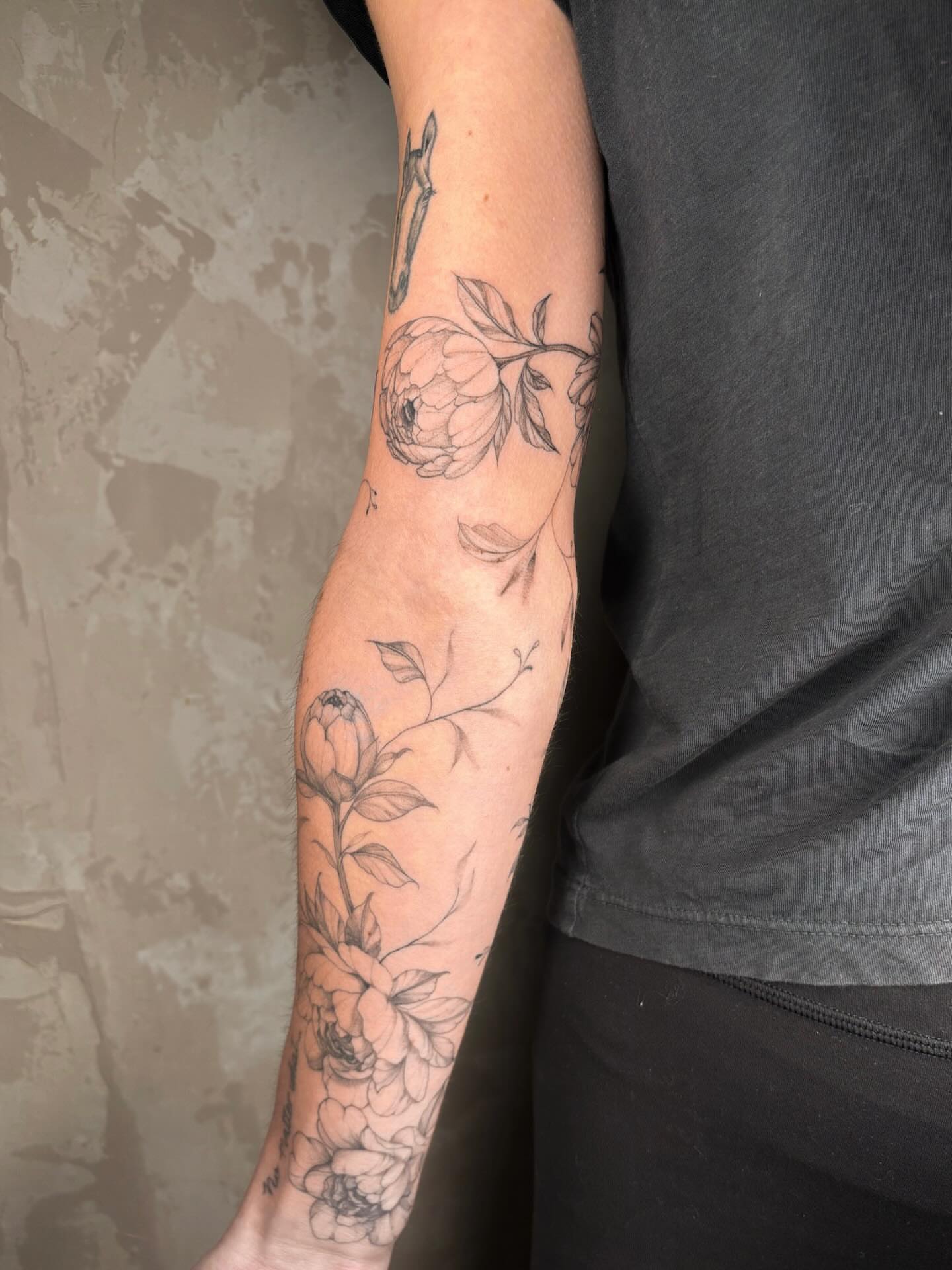 Peony flowers black and grey tattoo on the forearm by Annie