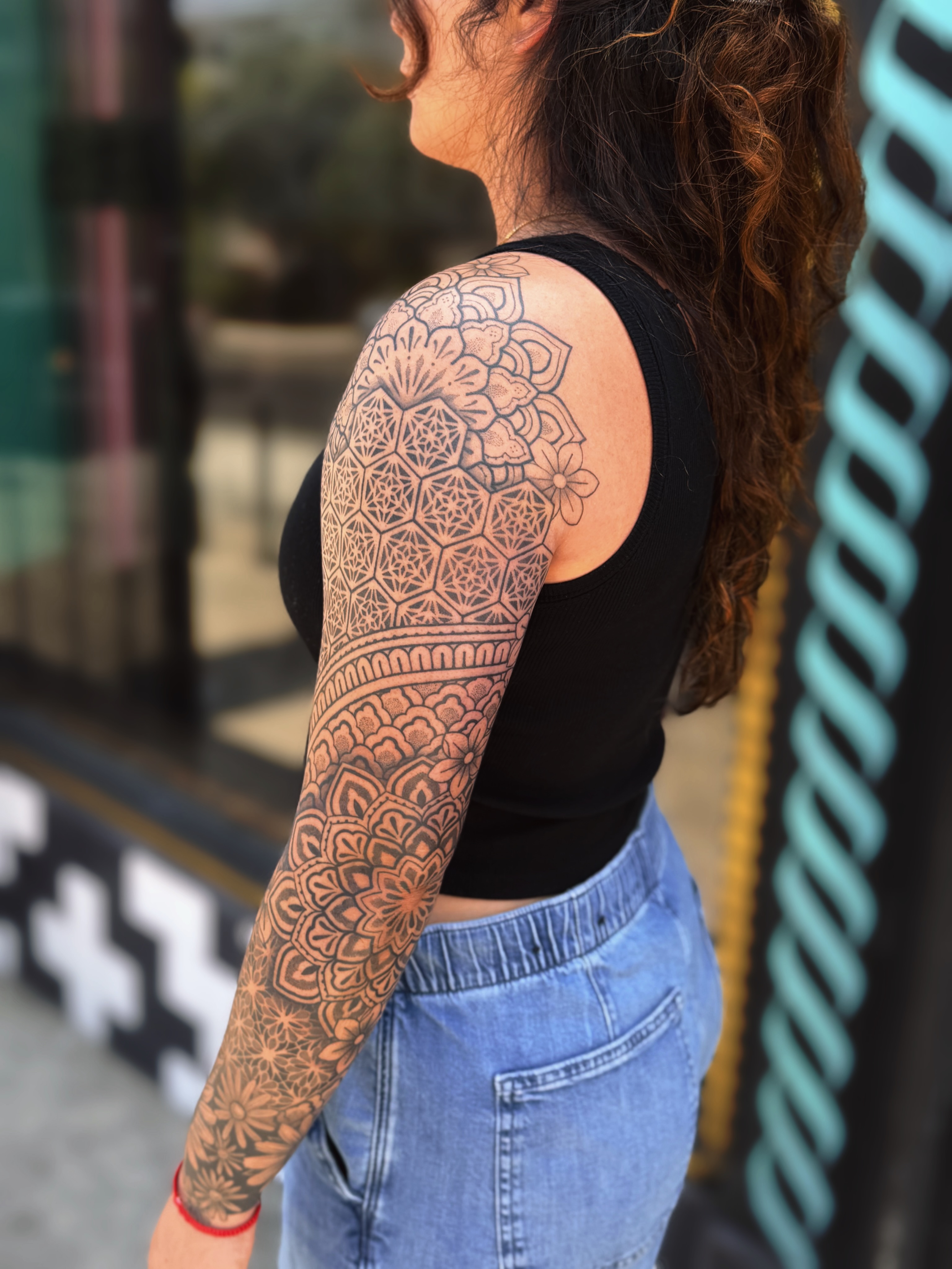 Mandala geometric tattoo on the upper arm by Storm Smith