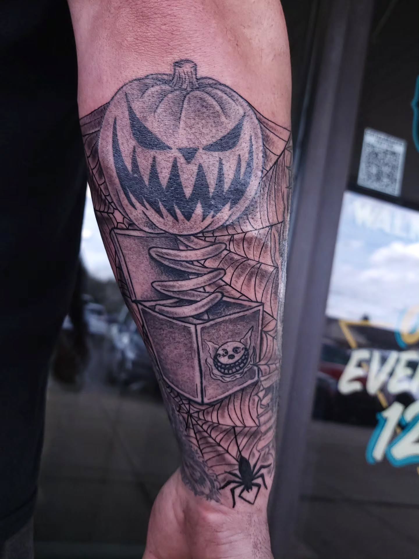 Pumpkin jack-o'-lantern black and grey tattoo on the forearm by xavia