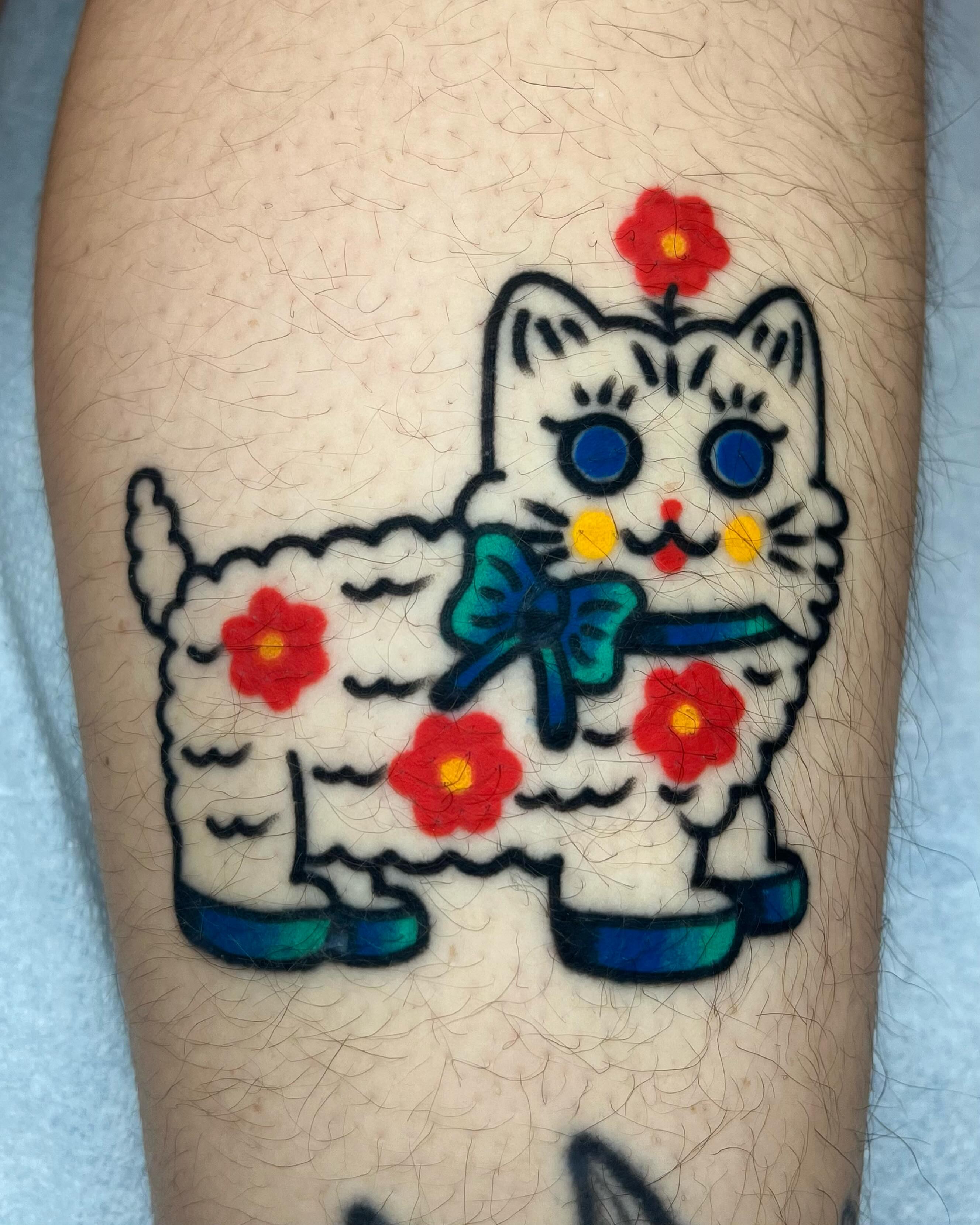 Maneki-neko American traditional tattoo on the forearm by Em Adkins