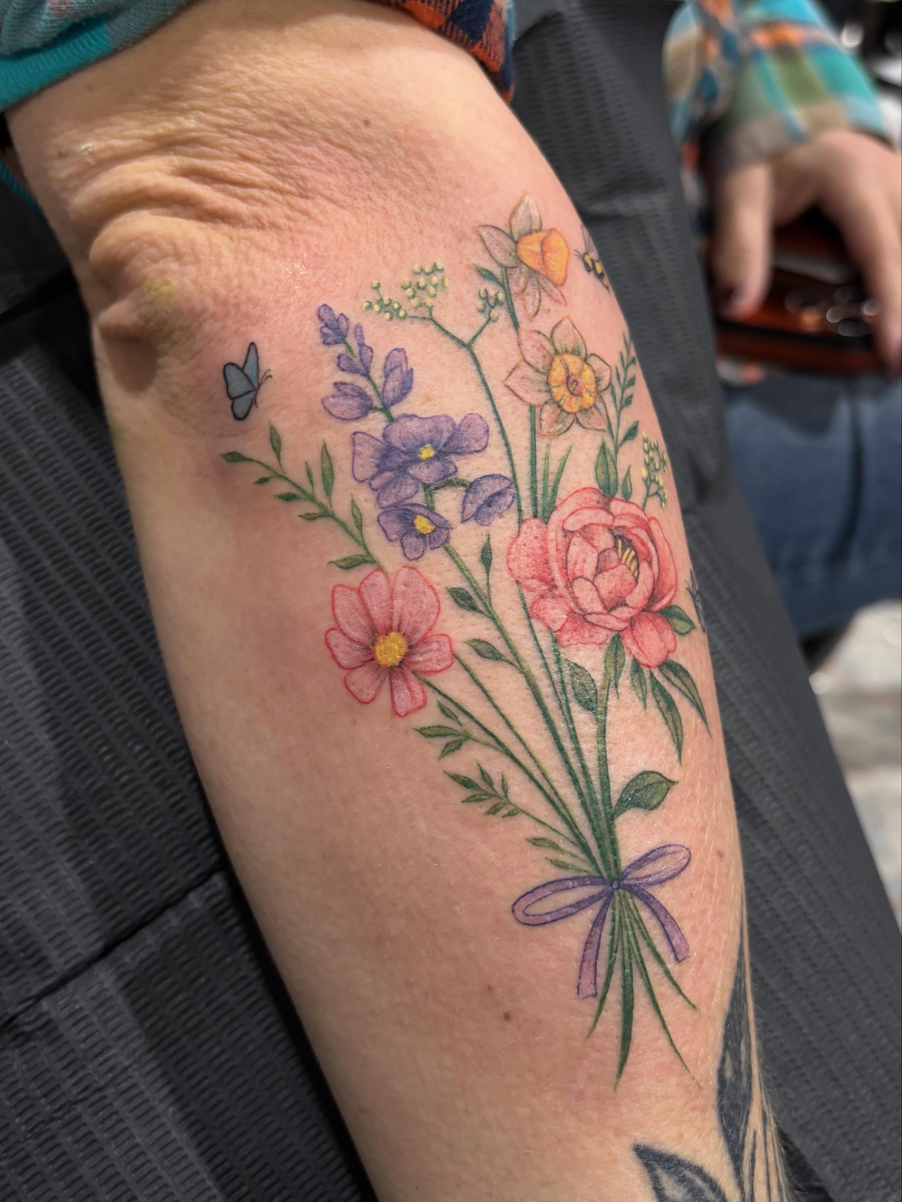 Flower bouquet new school tattoo on the forearm by Jennifer Flores