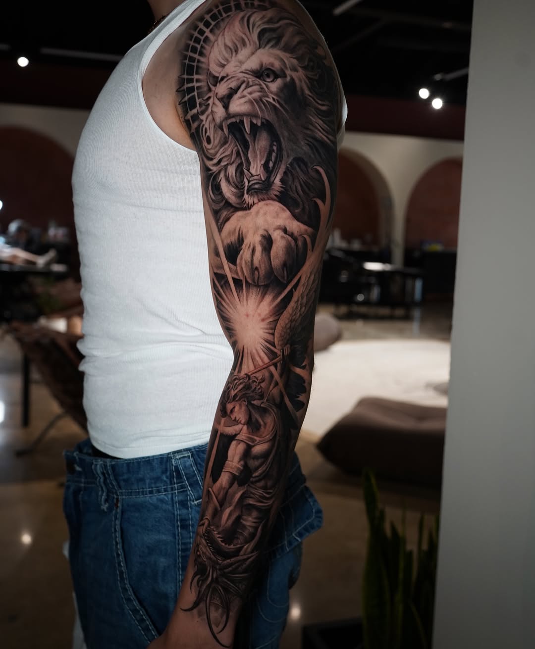 Lion and angel Japanese tattoo on the forearm by Grace P