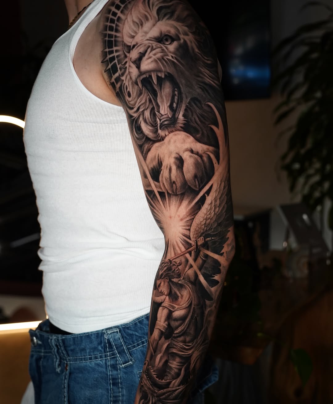 Lion and mythological figure realism tattoo on the forearm by Grace P