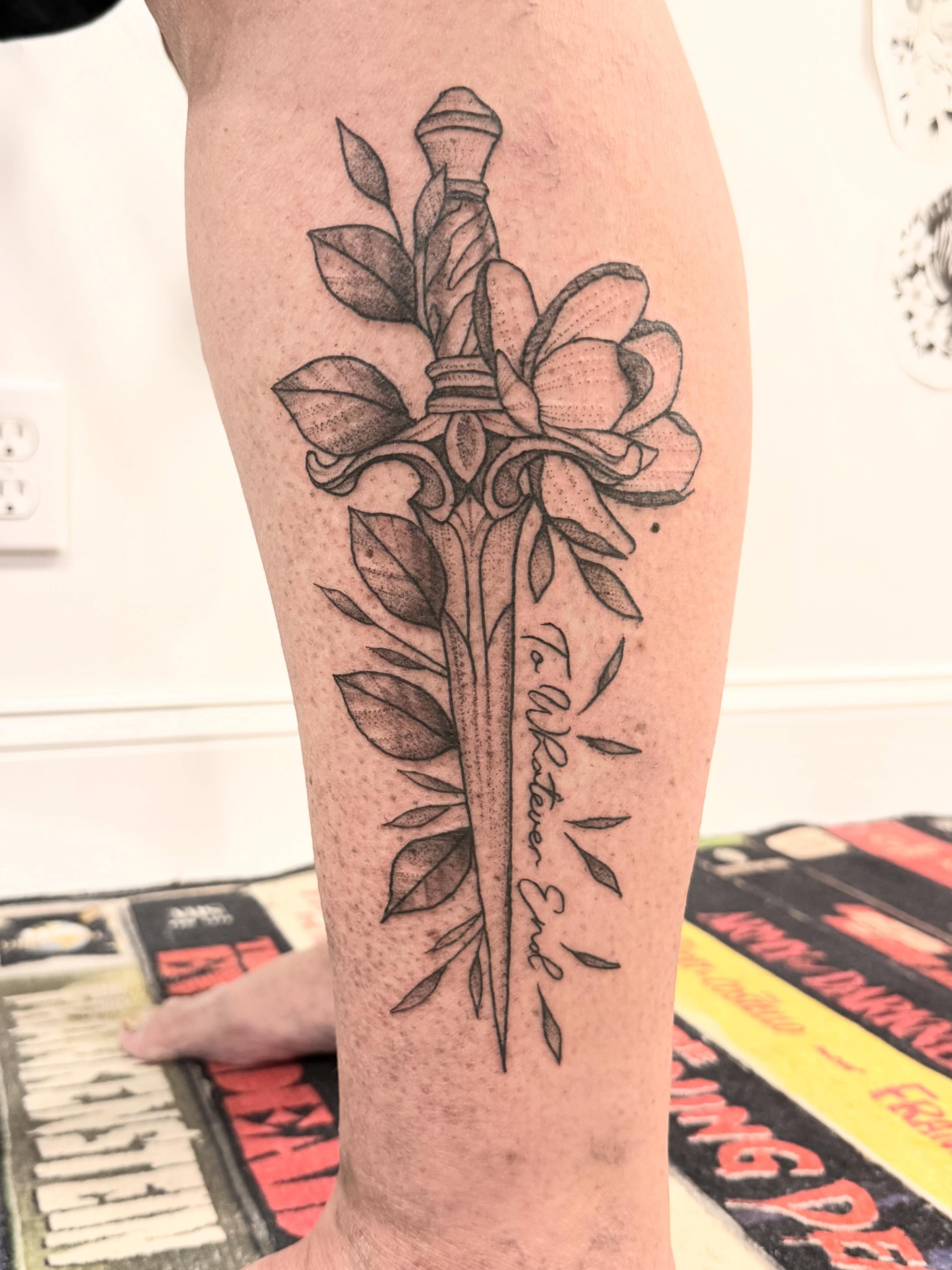 Sword and flower dotwork tattoo on the forearm by Shannon Misitano