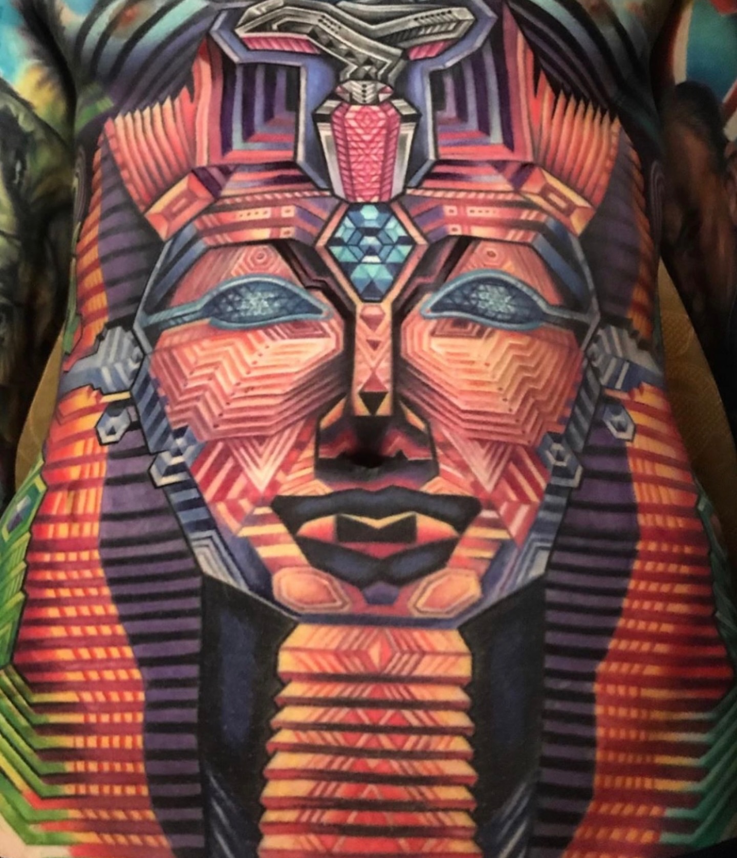 Pharaoh mask geometric tattoo on the chest by Mike Cole