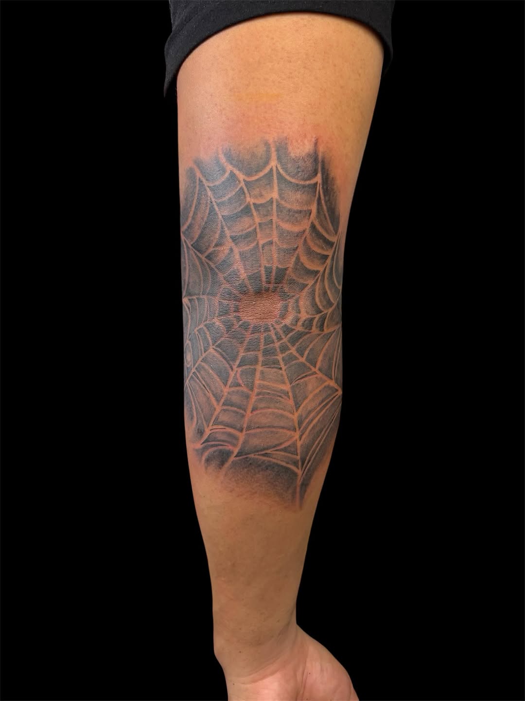Spider web blackwork tattoo on the forearm by @inkwitatlas