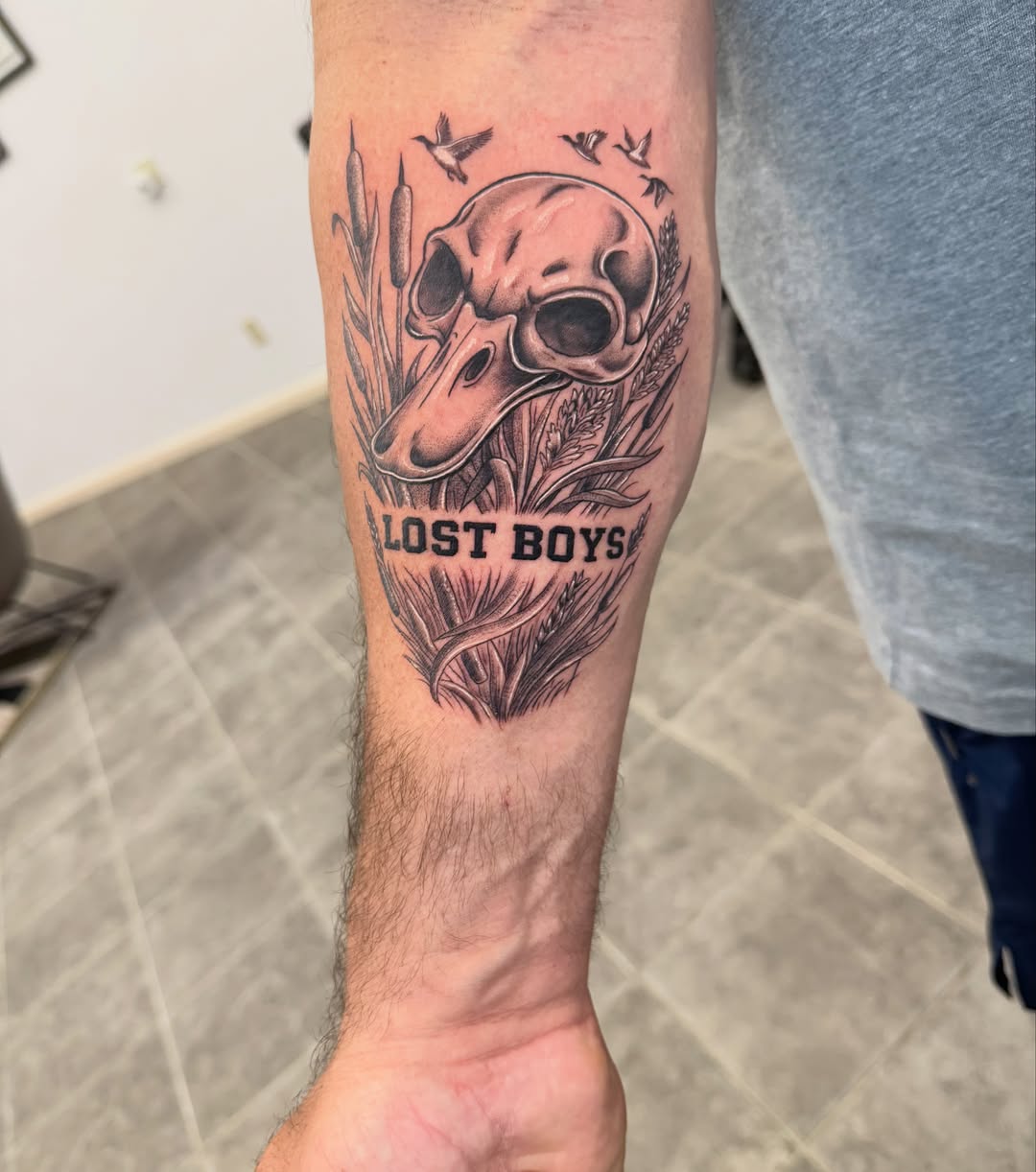 Skull and wheat black and grey tattoo on the forearm by Juan Guzman