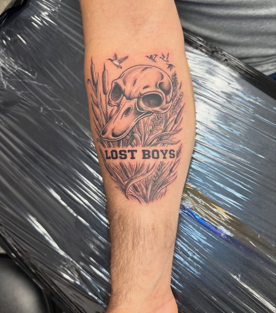 Deer skull and cattails American traditional tattoo on the forearm by Juan Guzman