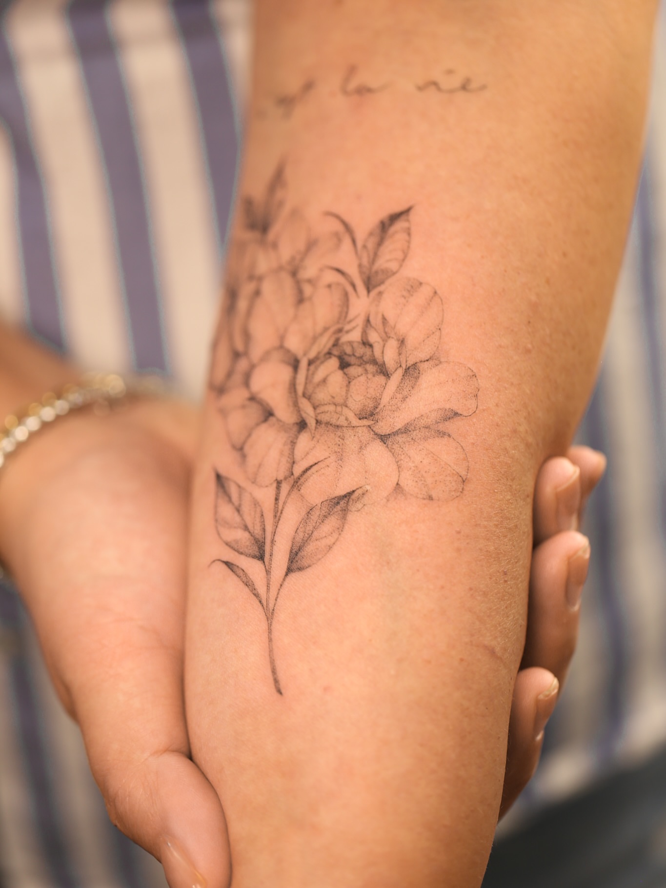 Flower black and grey tattoo on the forearm by Inna Petrova, Kitchener, Ontario