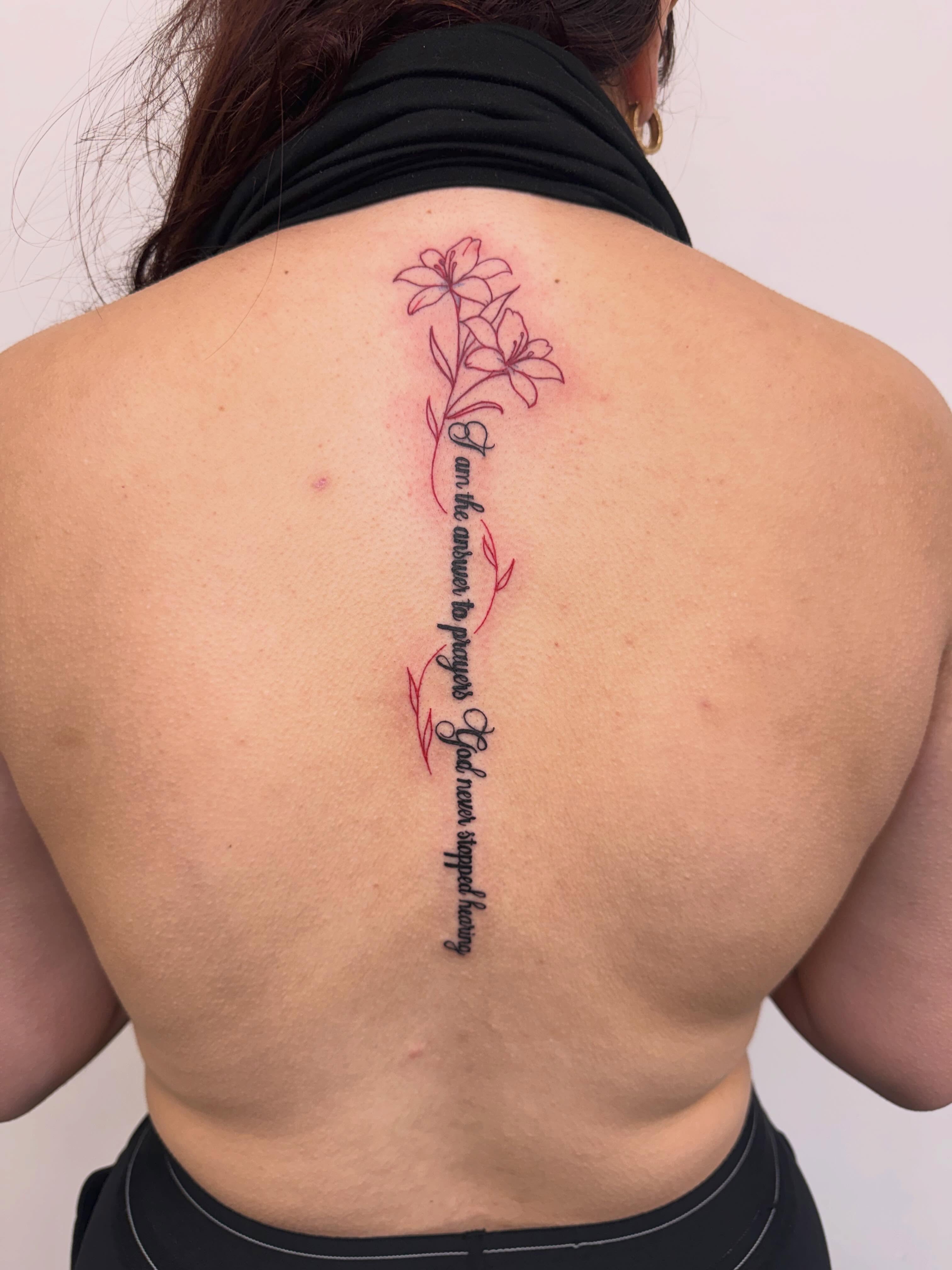 Lilies and script fine line tattoo on the back by Angela Nery, South Jordan, Utah