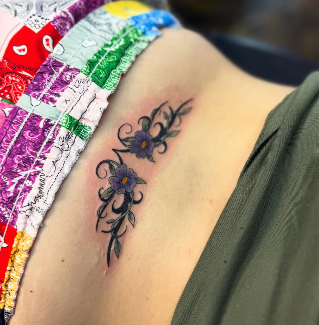 Purple flowers new school tattoo on the ribs by Jada Reynolds