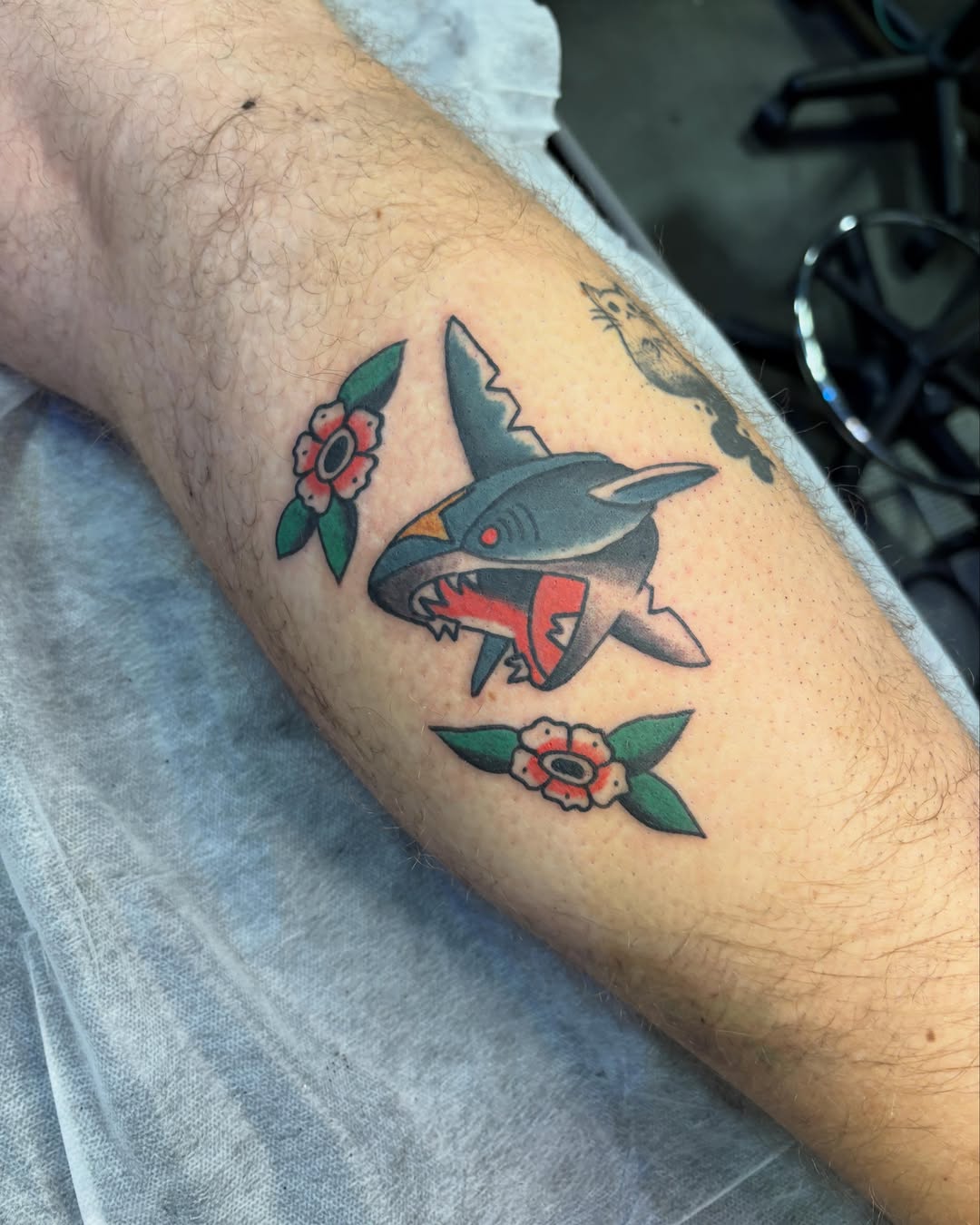 Shark and flowers American traditional tattoo on the forearm by Sammy Tattoo, Austin, Texas