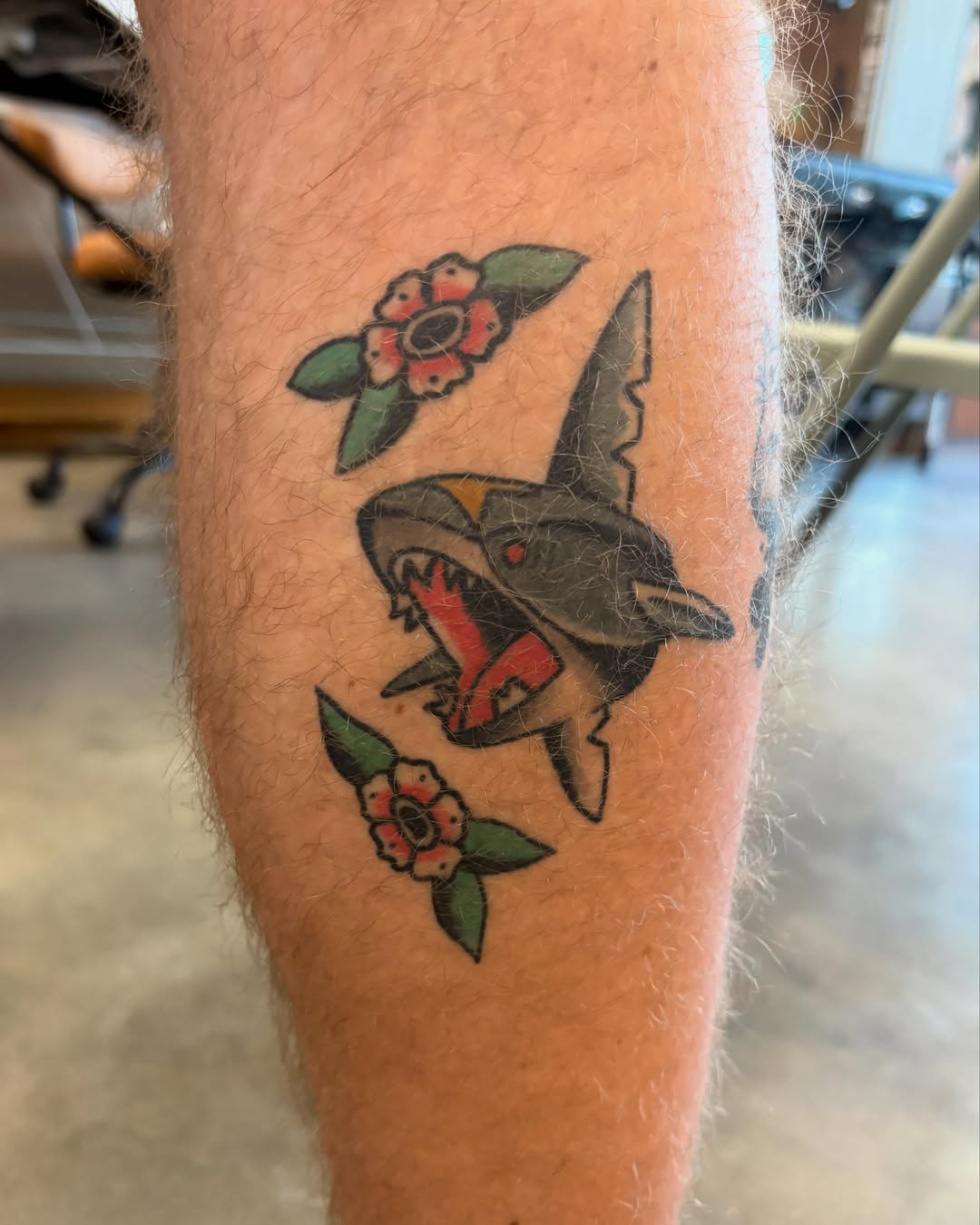 Shark with flowers American traditional tattoo on the forearm by Sammy Tattoo, Austin, Texas