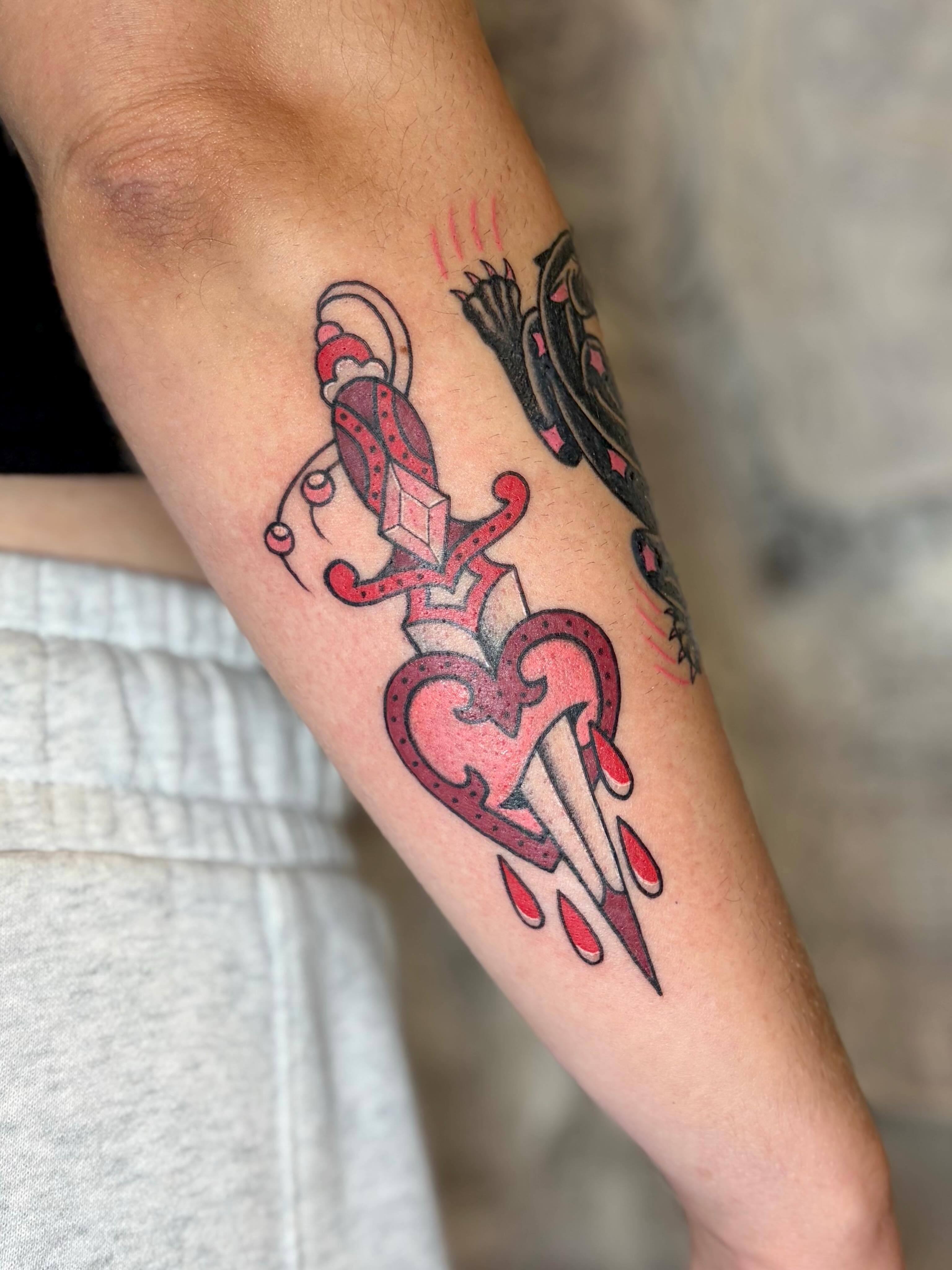 Heart with dagger American traditional tattoo on the forearm by Danelle ✶ Nashville Tattooer
