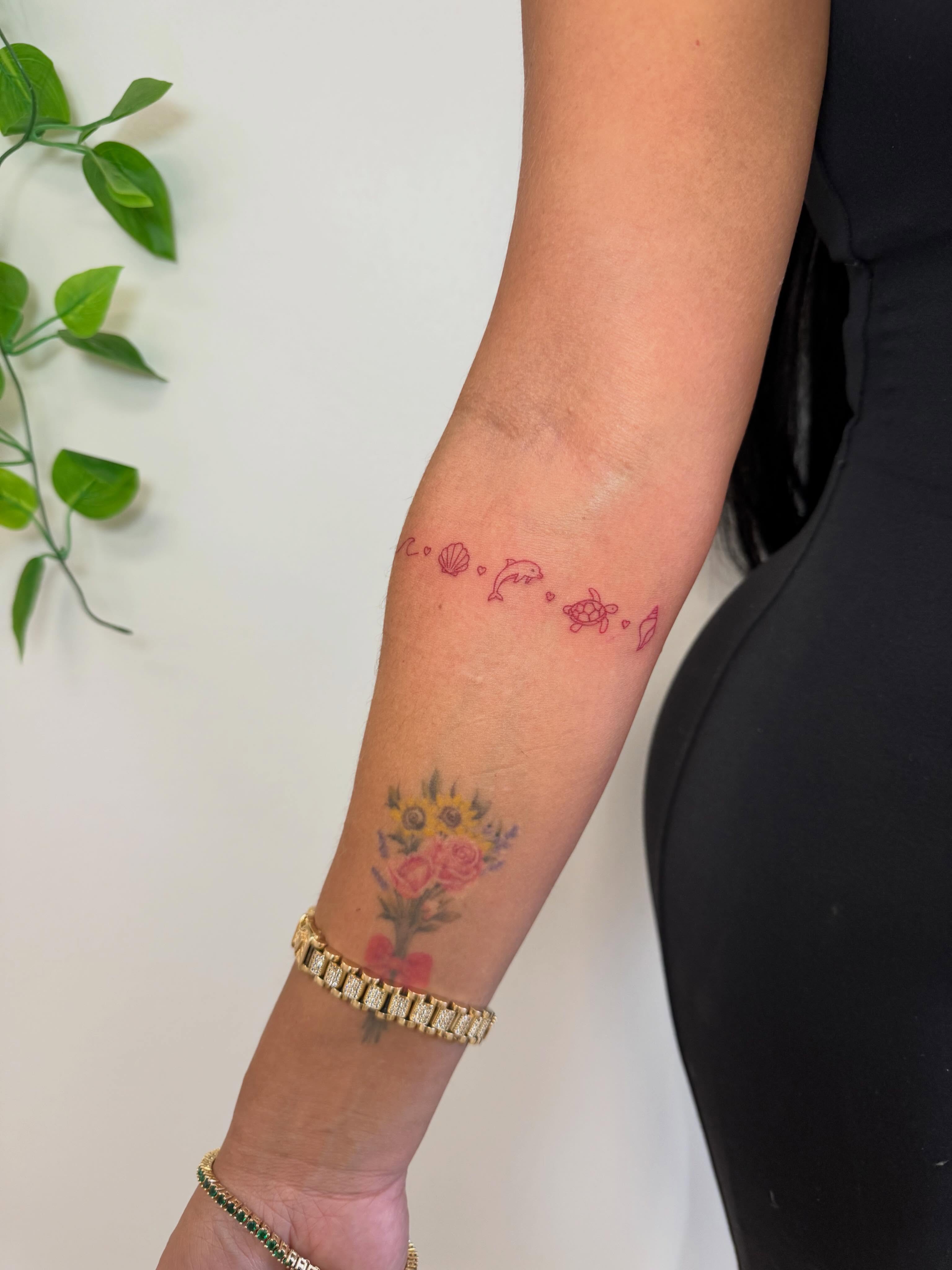 Flowers and sea creatures dotwork tattoo on the forearm by Angela Nery, South Jordan, Utah