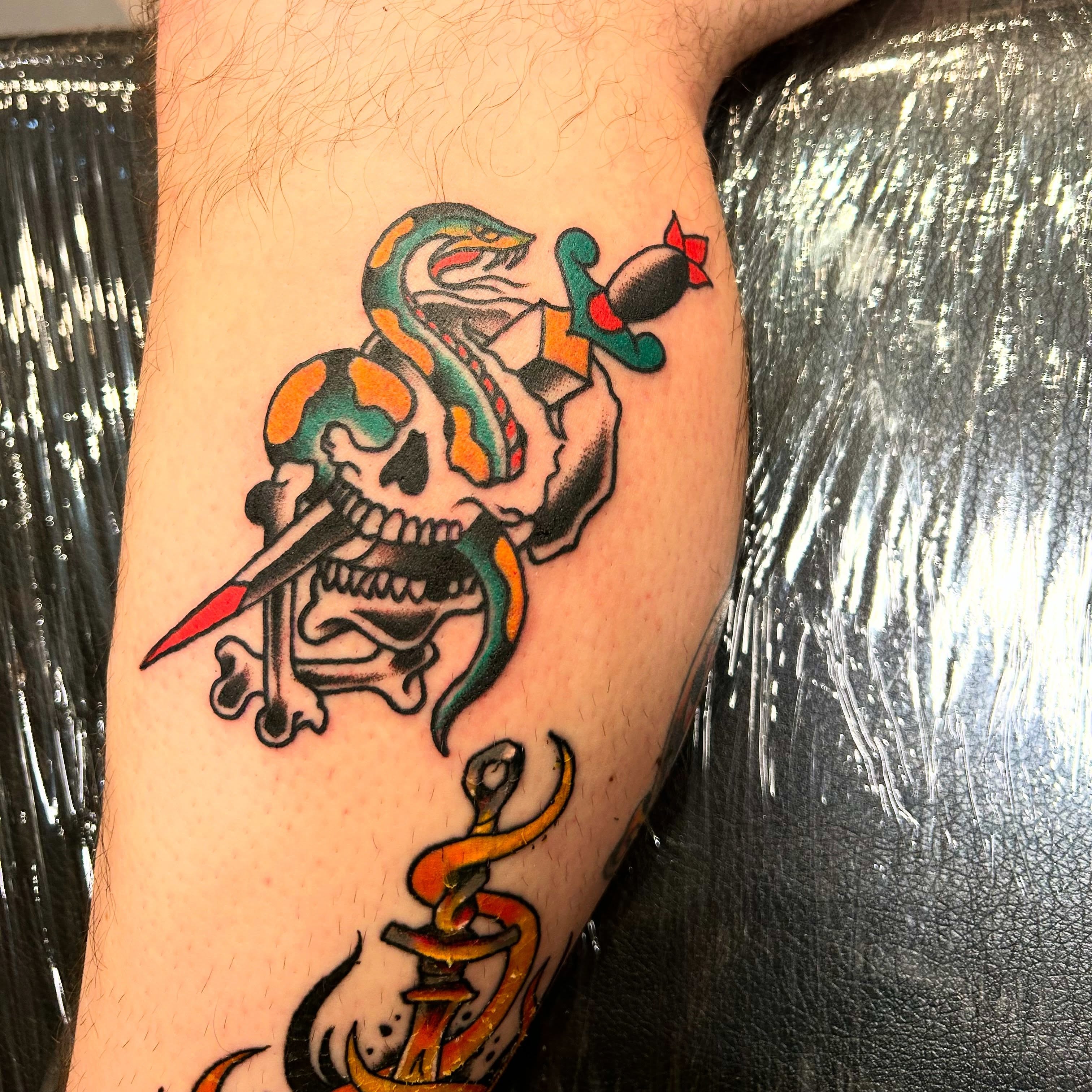 Skull and snake American traditional tattoo on the forearm by Erik Sacony