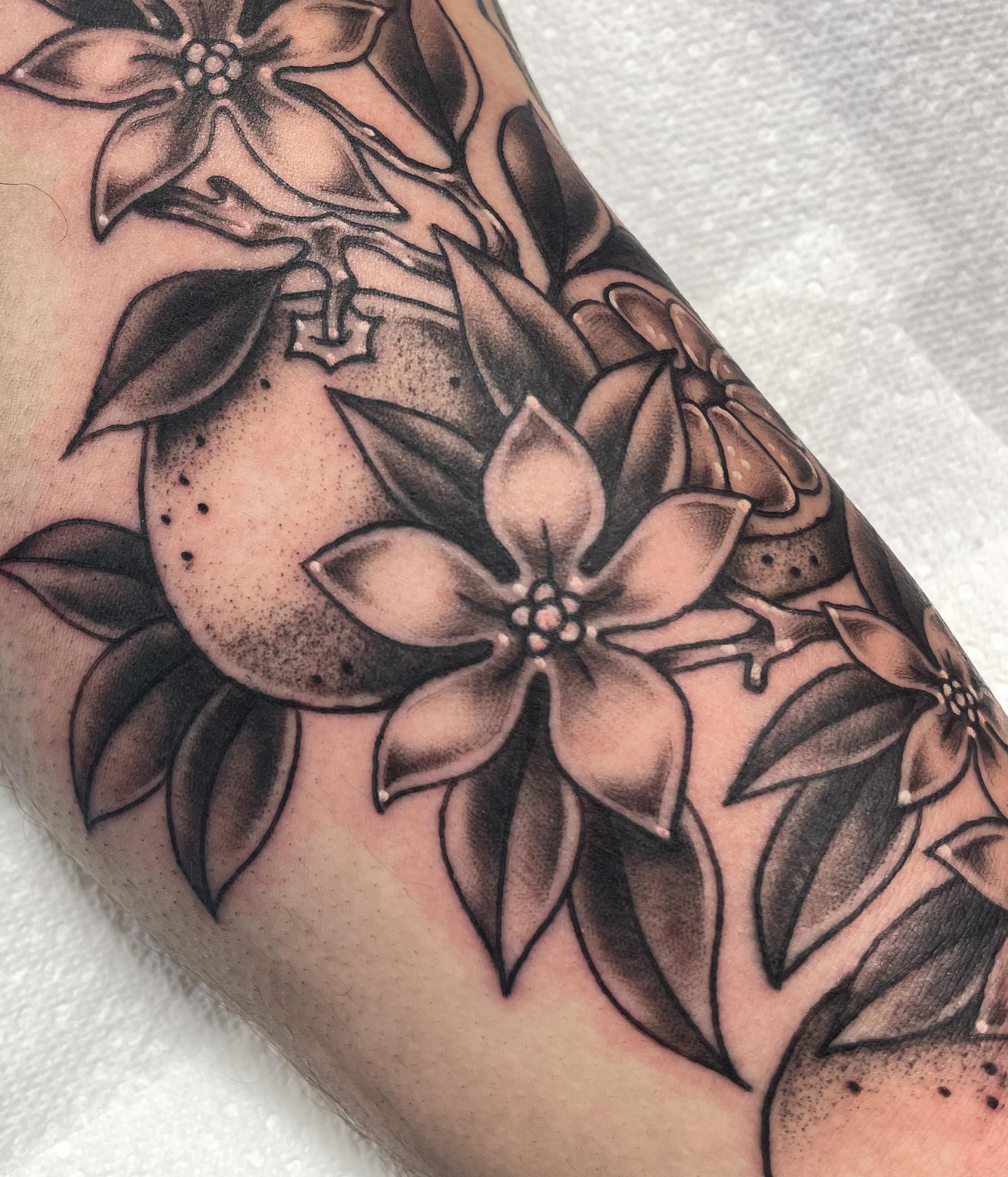 Flowers black and grey tattoo on the forearm by Eric (EK) Kuldell