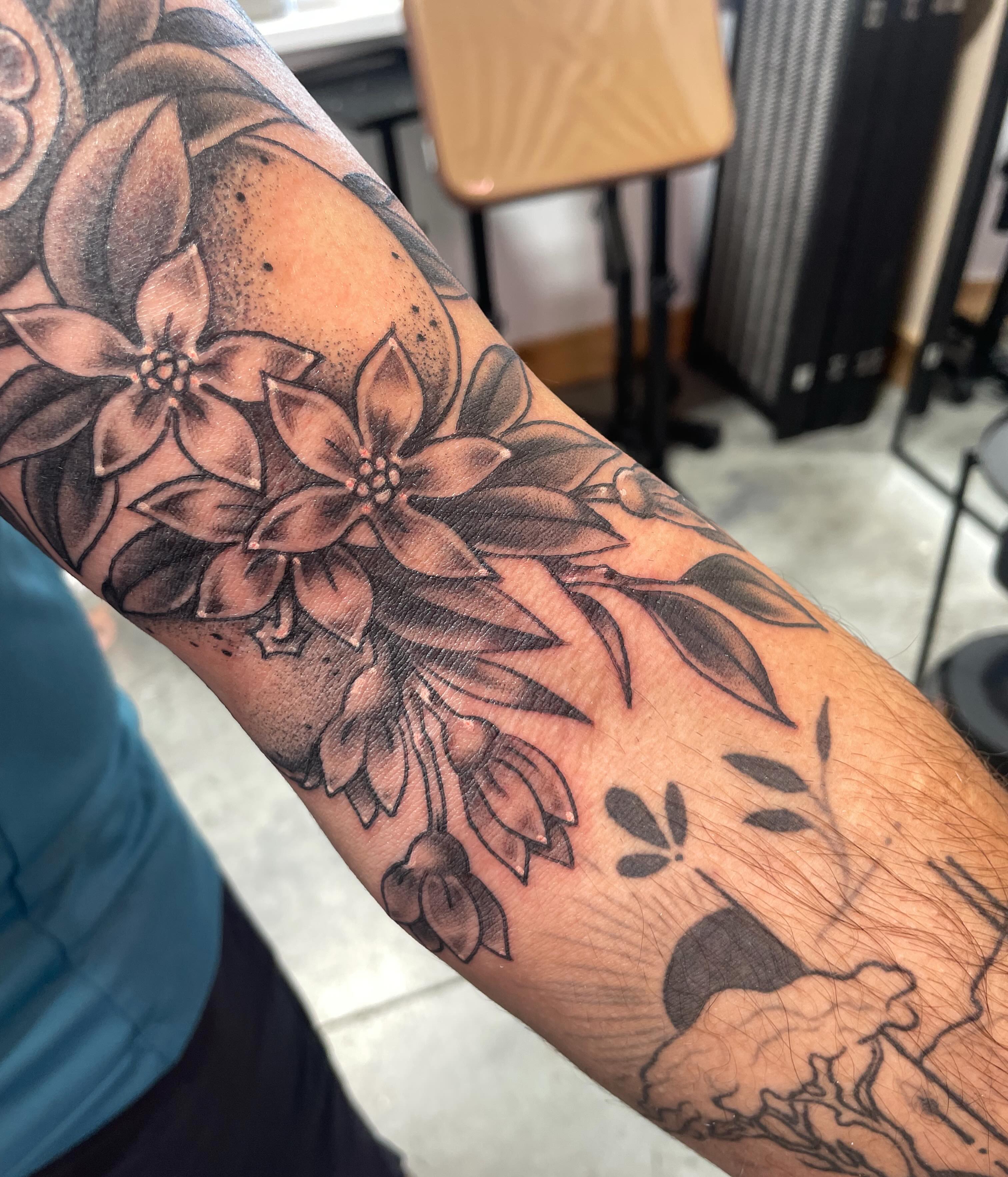 Flowers black and grey tattoo on the forearm by Eric (EK) Kuldell