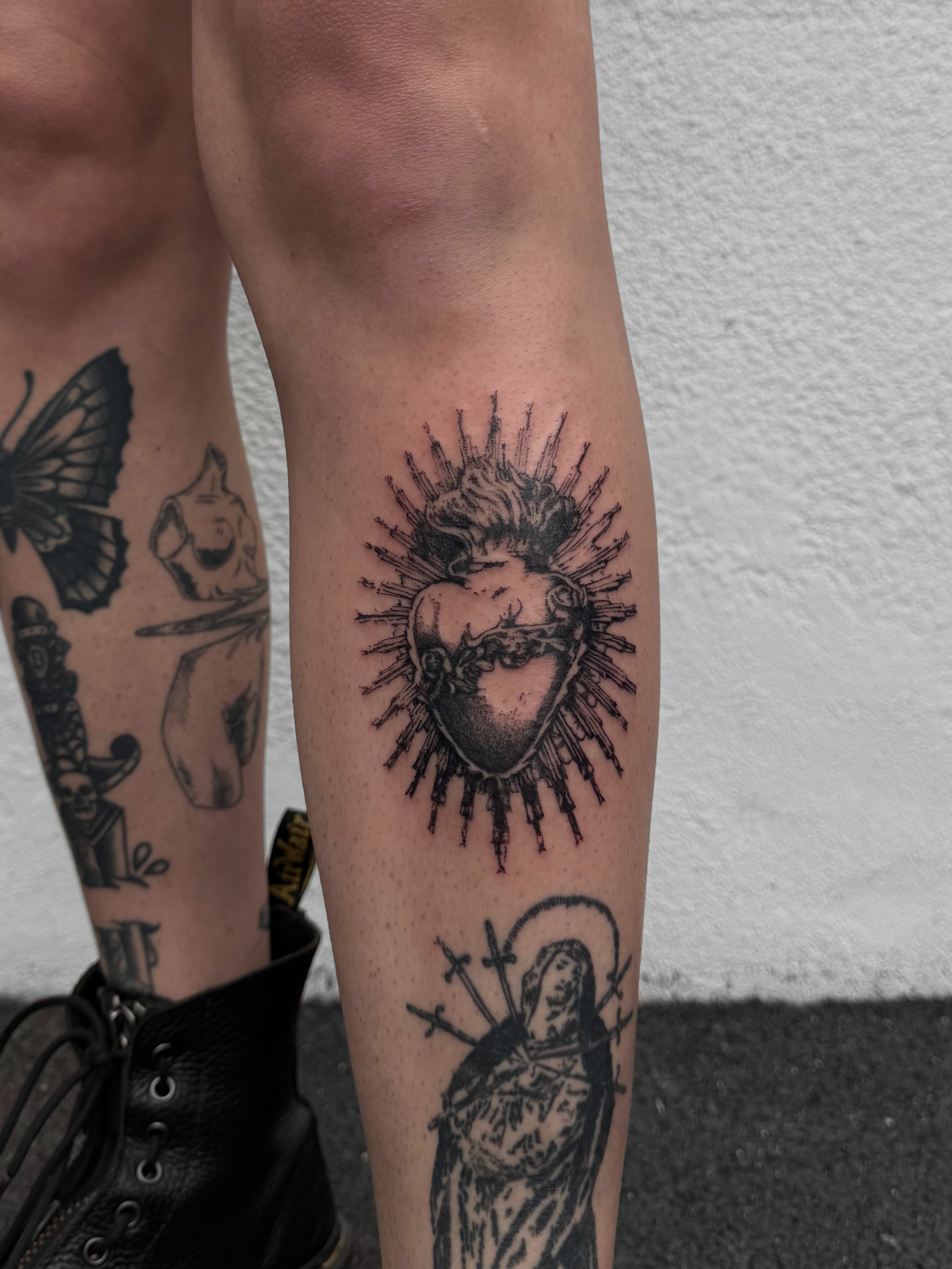 Heart with spikes black and grey tattoo on the forearm by Ava Nilou