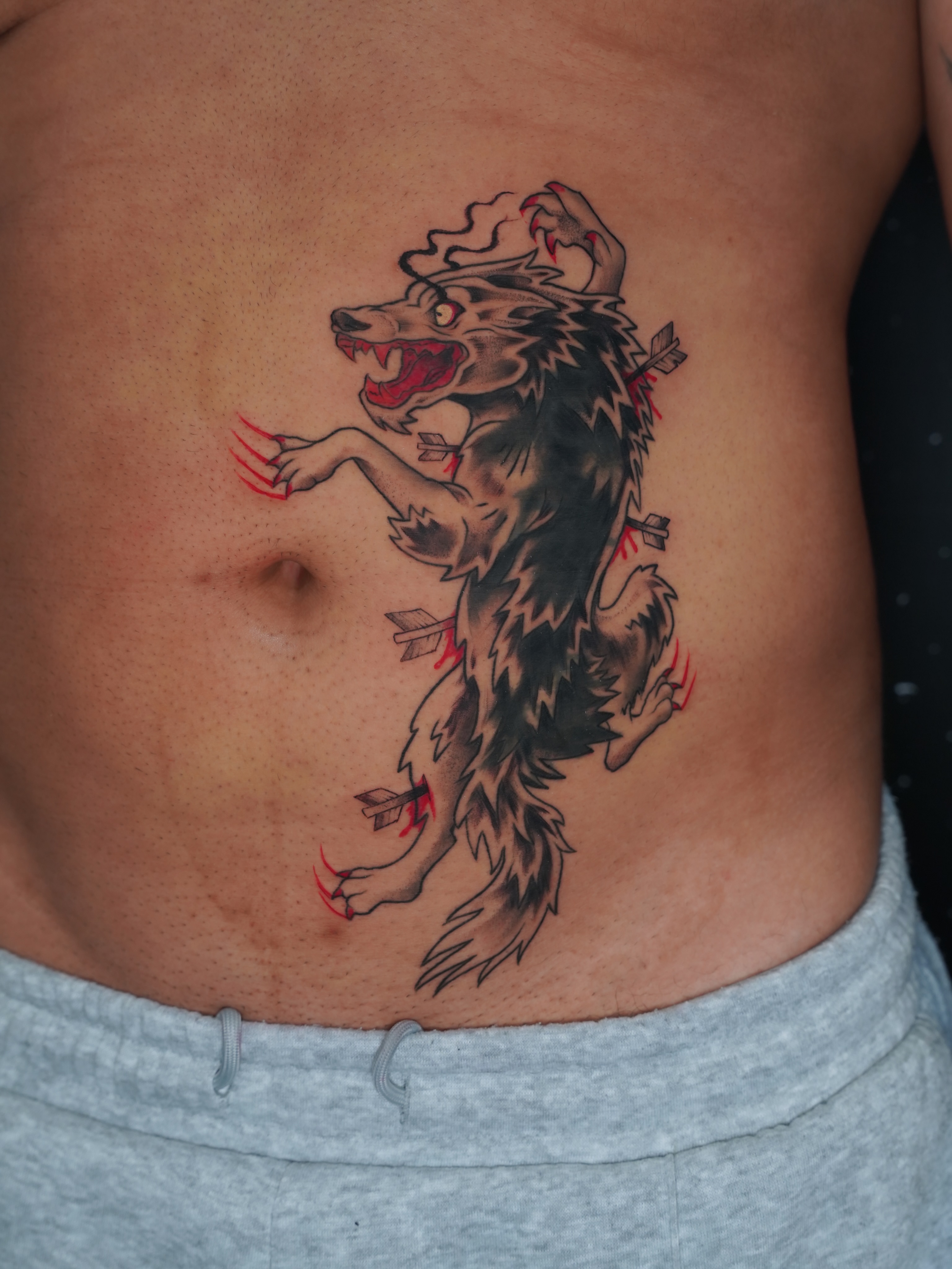 Wolf American traditional tattoo on the ribs by Derek Foferek, Charlotte, North Carolina
