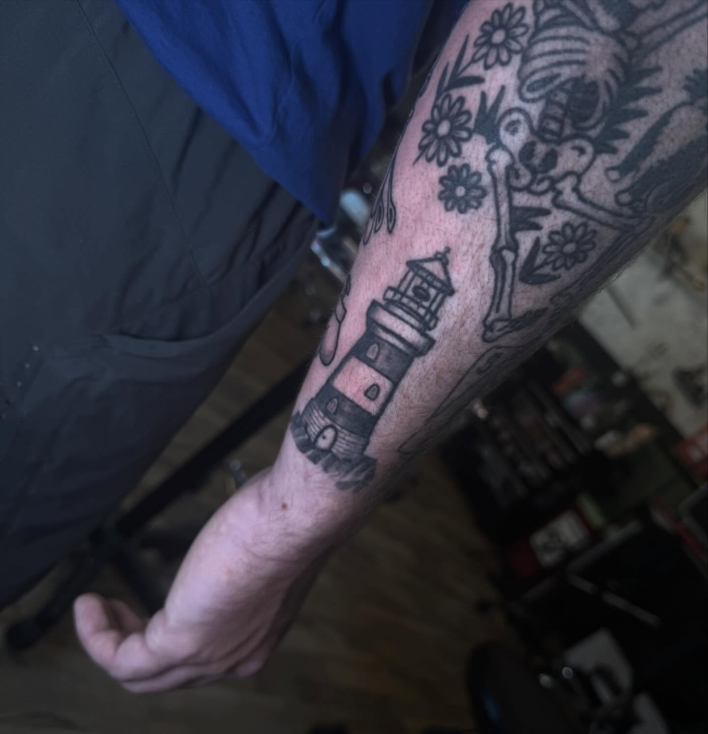 Lighthouse black and grey tattoo on the forearm by Mtctattoos