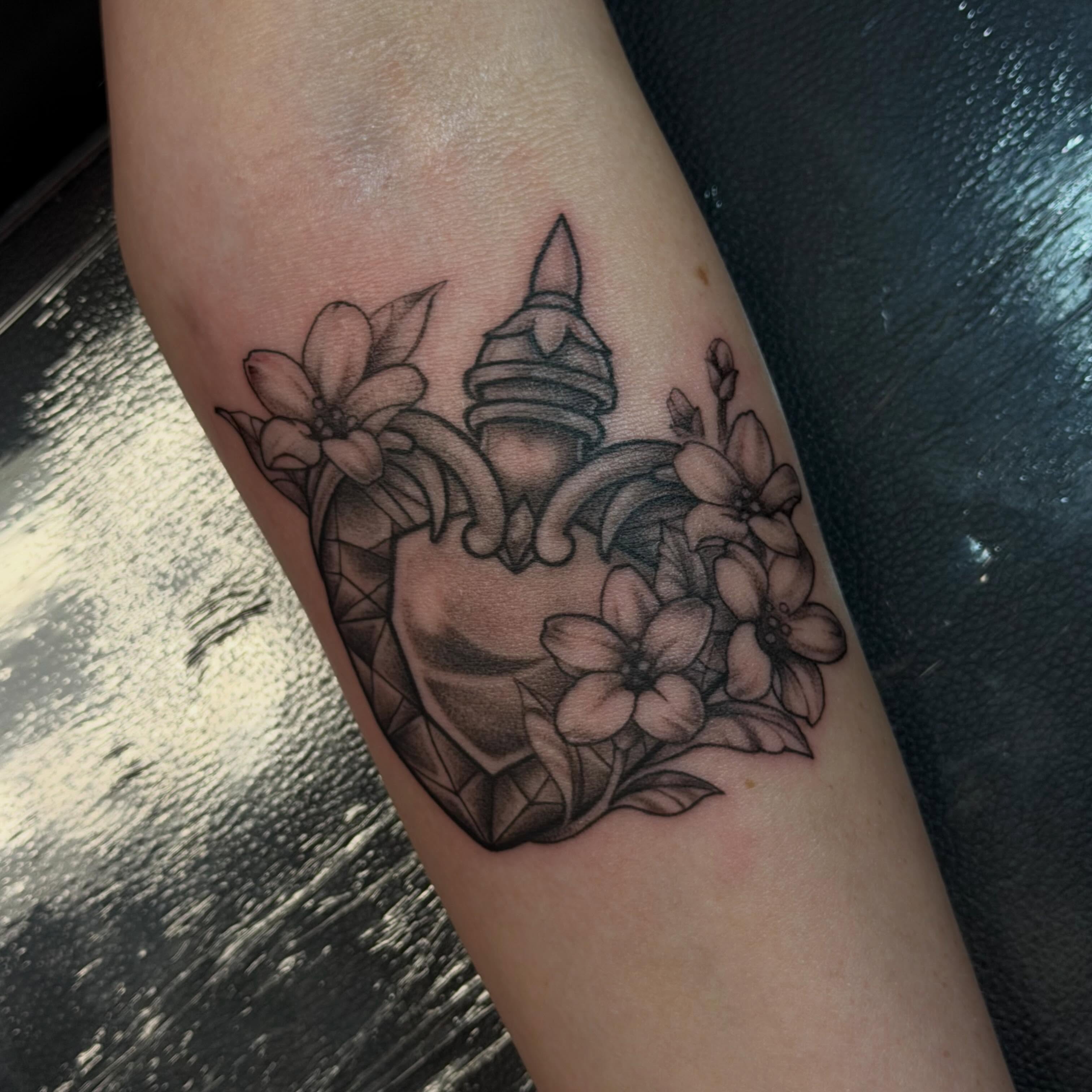 Heart with knight helmet geometric tattoo on the forearm by Trista Bettfreund (Birdy)