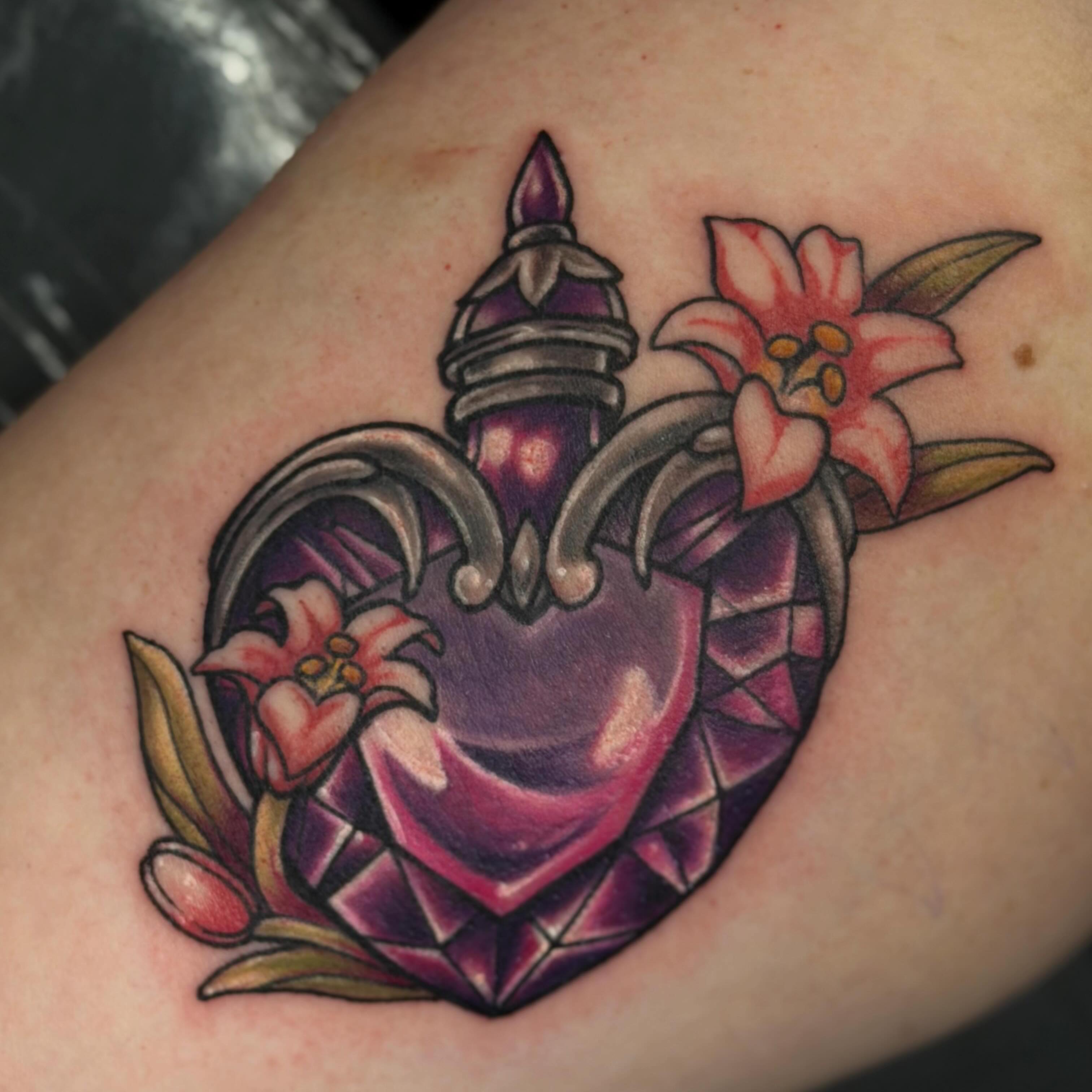 Heart with flowers geometric tattoo on the upper arm by Trista Bettfreund (Birdy)