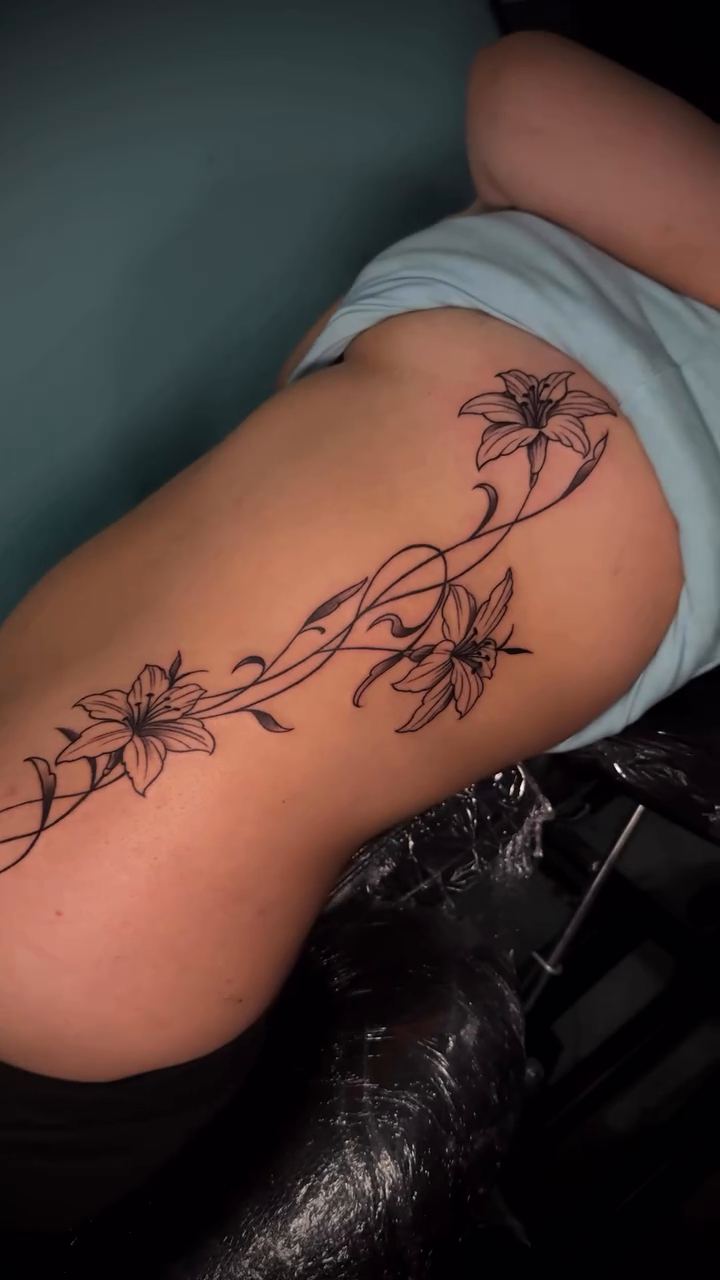 Floral vine tattoo on hip fine line tattoo on the thigh by Tony Hernandez, Chicago, Illinois