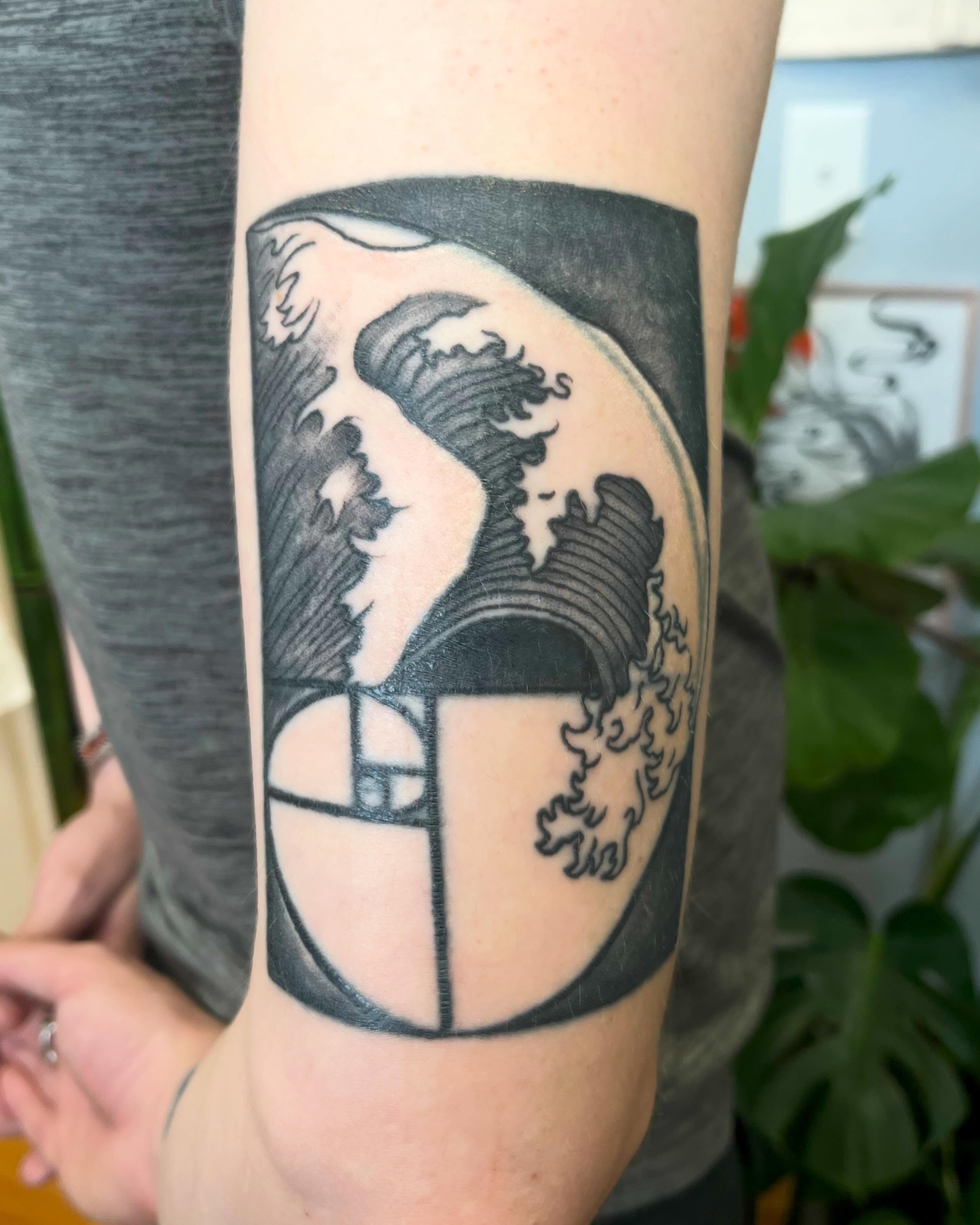 Wave geometric tattoo on the forearm by Garden Glow Tattoo