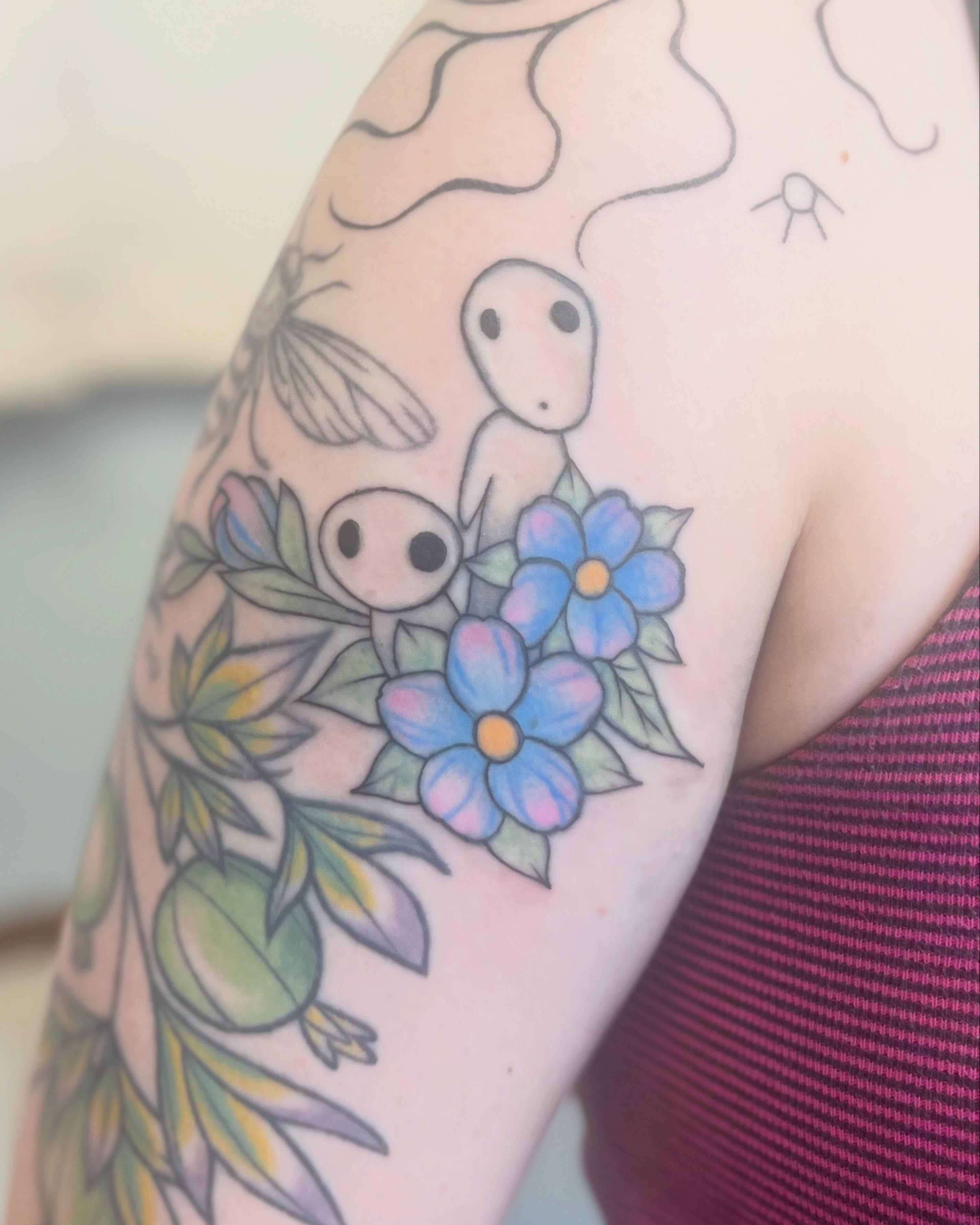 Forget-me-not flowers dotwork tattoo on the upper arm by Garden Glow Tattoo