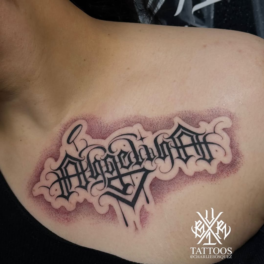 Script lettering Chicano tattoo on the chest by El Beaver Tattoos