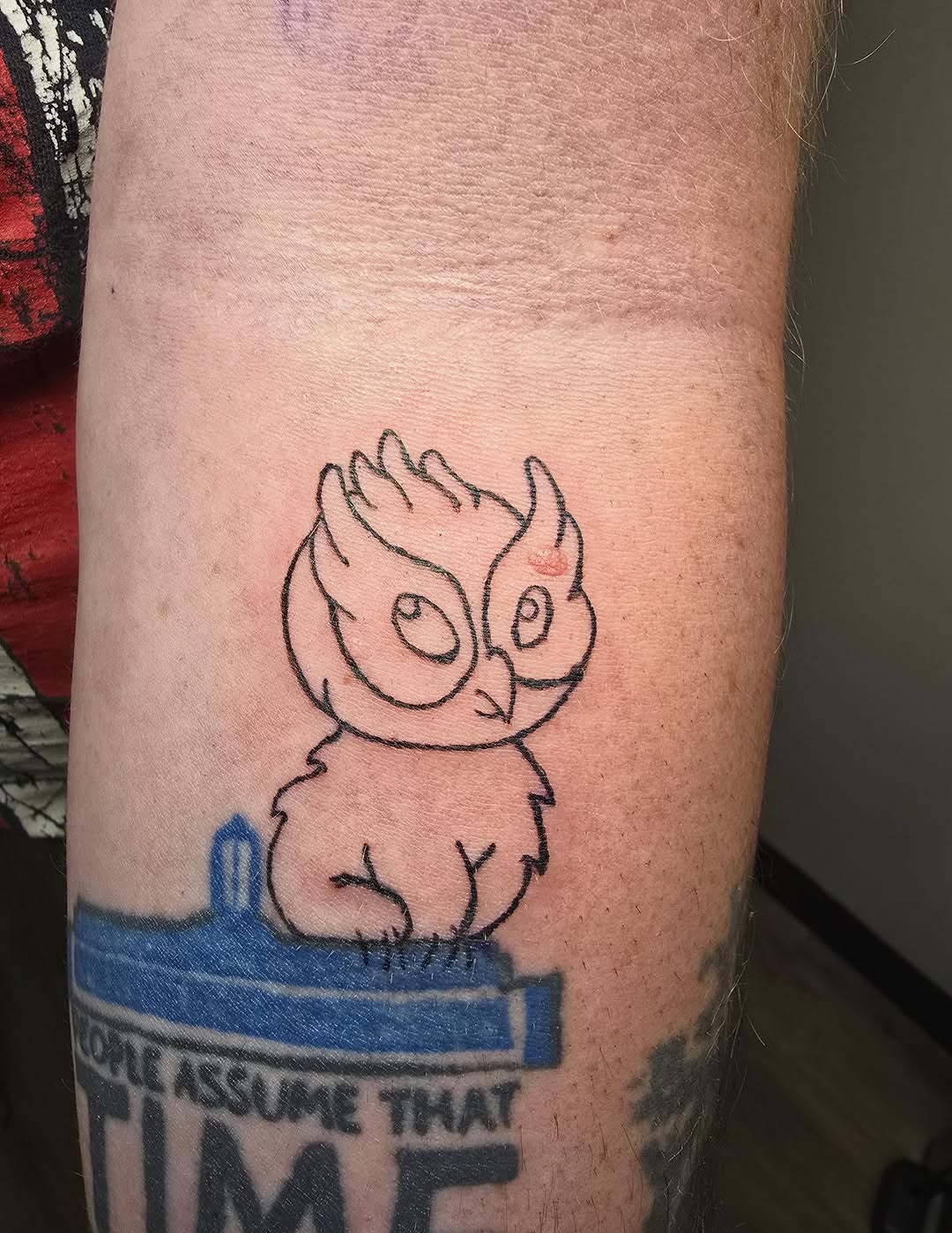 Cartoon owl tattoo on the forearm by Catherine B