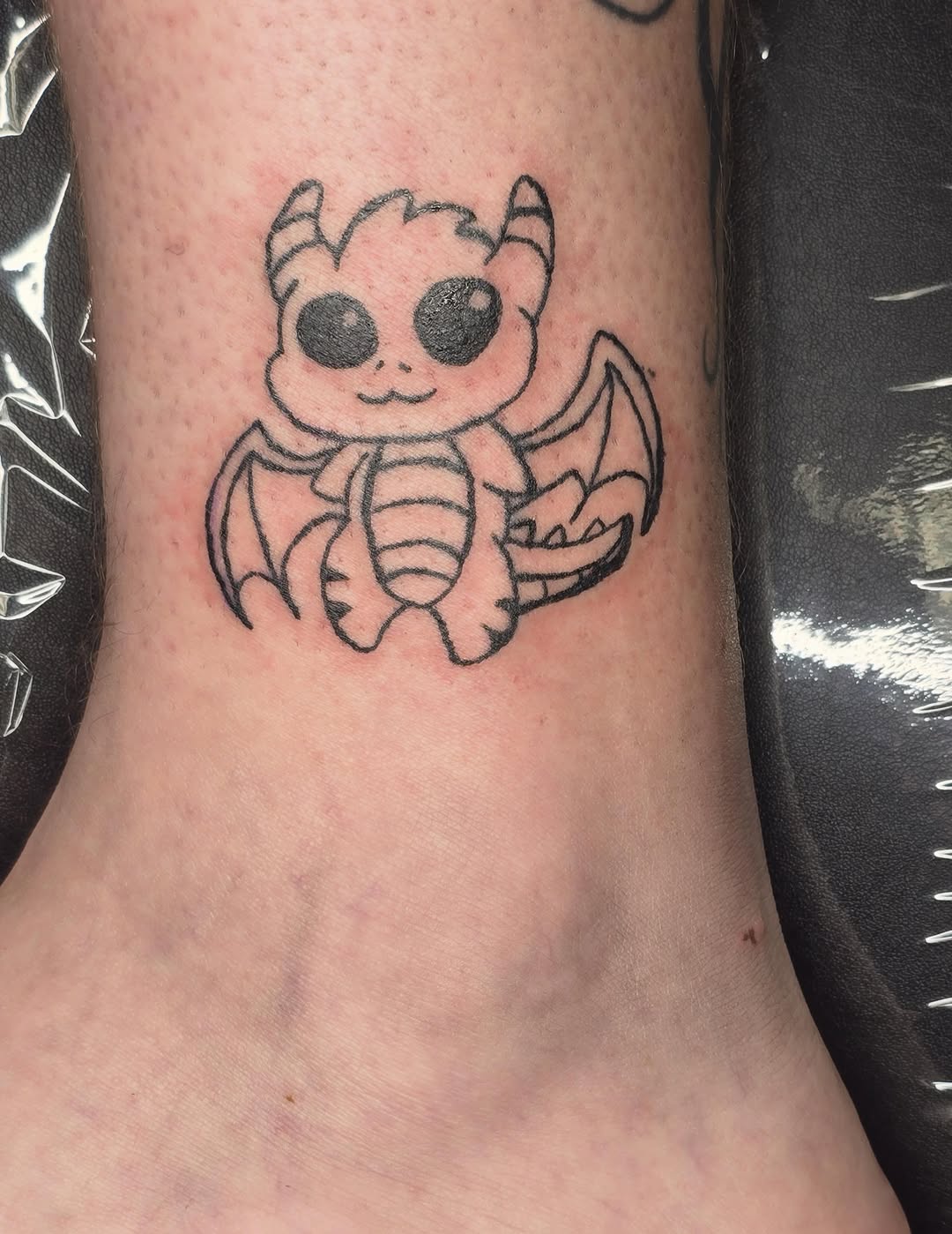 Cute dragon new school tattoo on the forearm by Catherine B