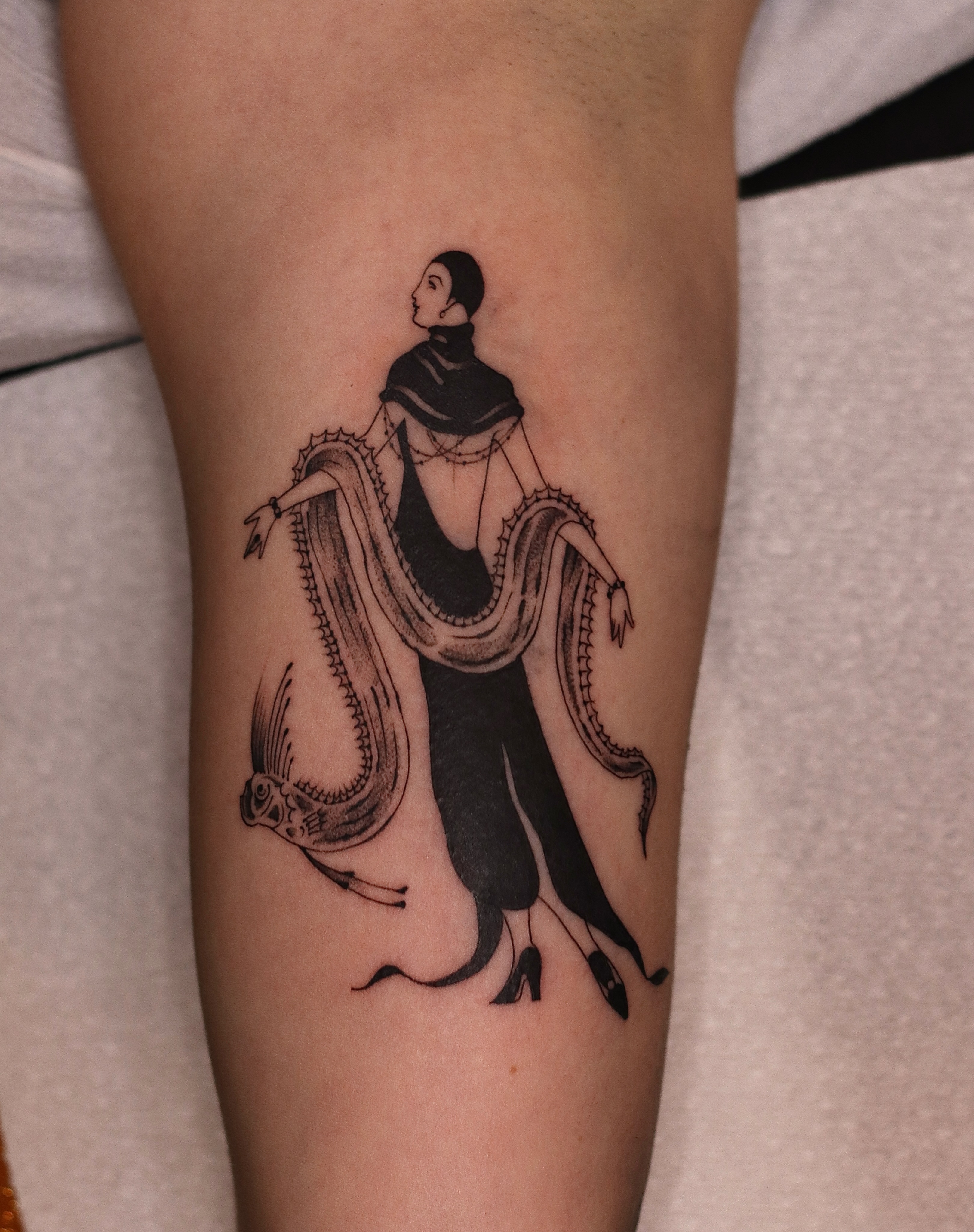 Woman with snake black and grey tattoo on the forearm by Nik Checots