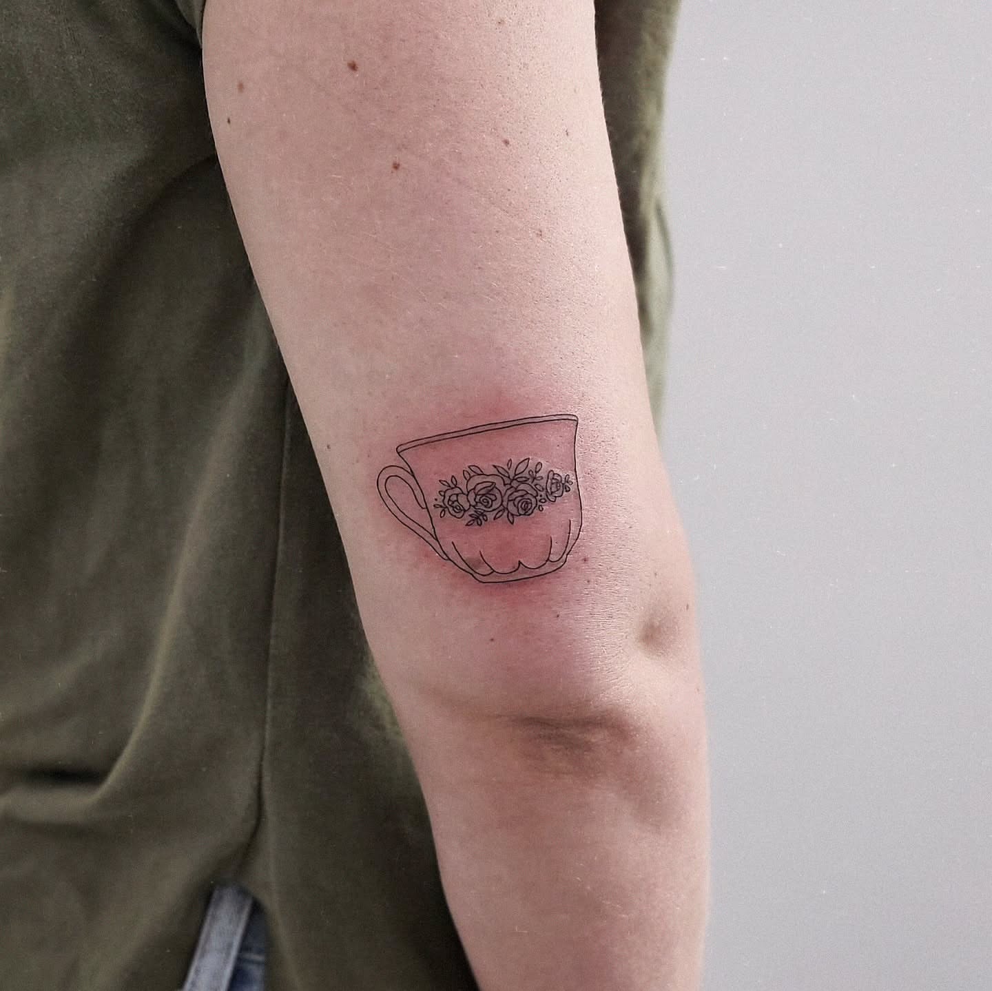 Teacup with floral design black and grey tattoo on the forearm by Jenny ✴︎ 제니