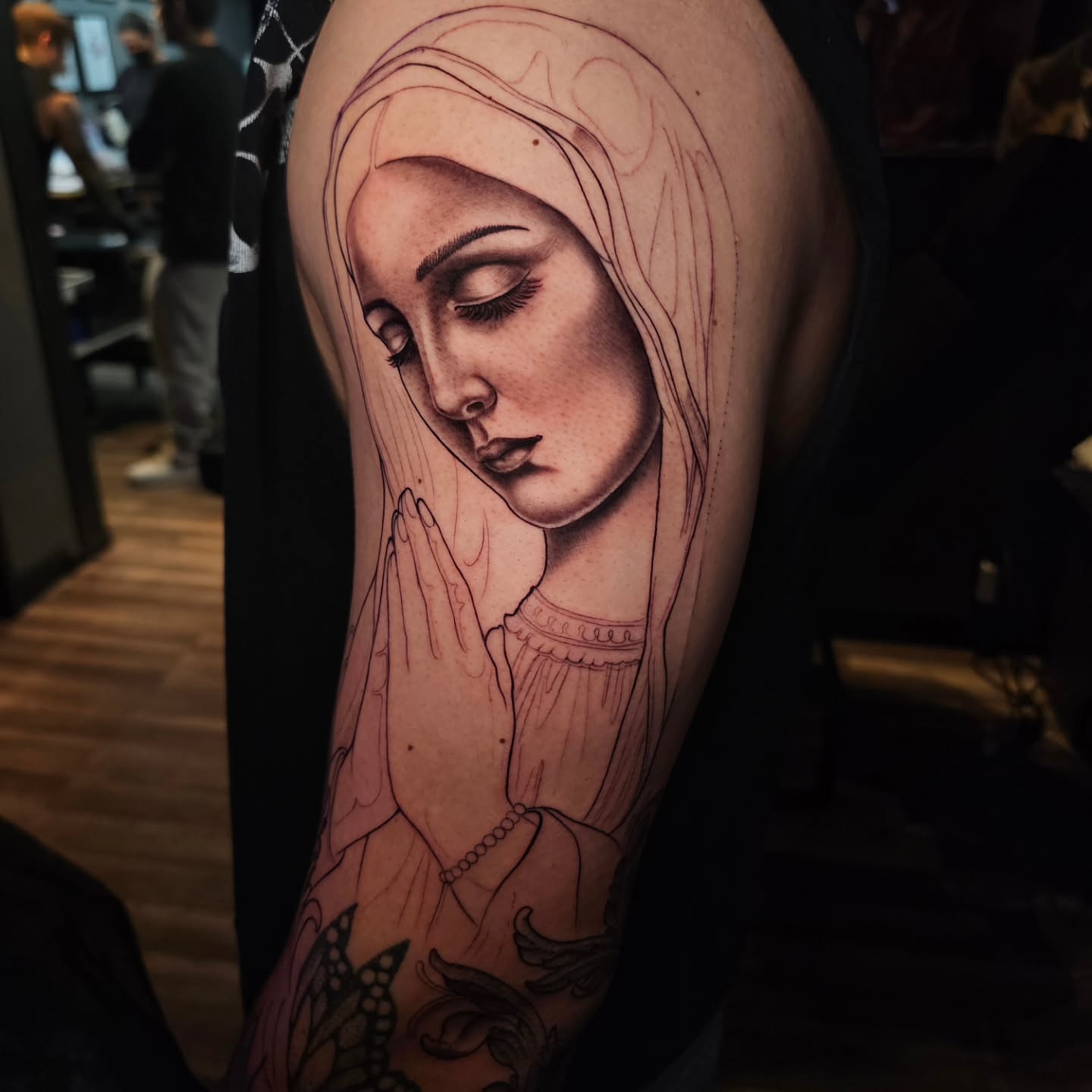 Praying woman realism tattoo on the forearm by Adriannah Esparza