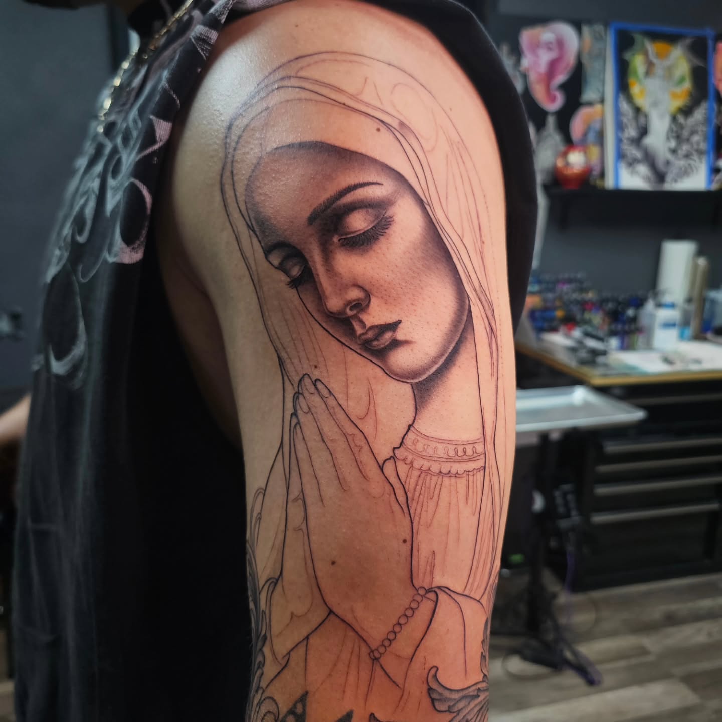 Praying nun realism tattoo on the upper arm by Adriannah Esparza