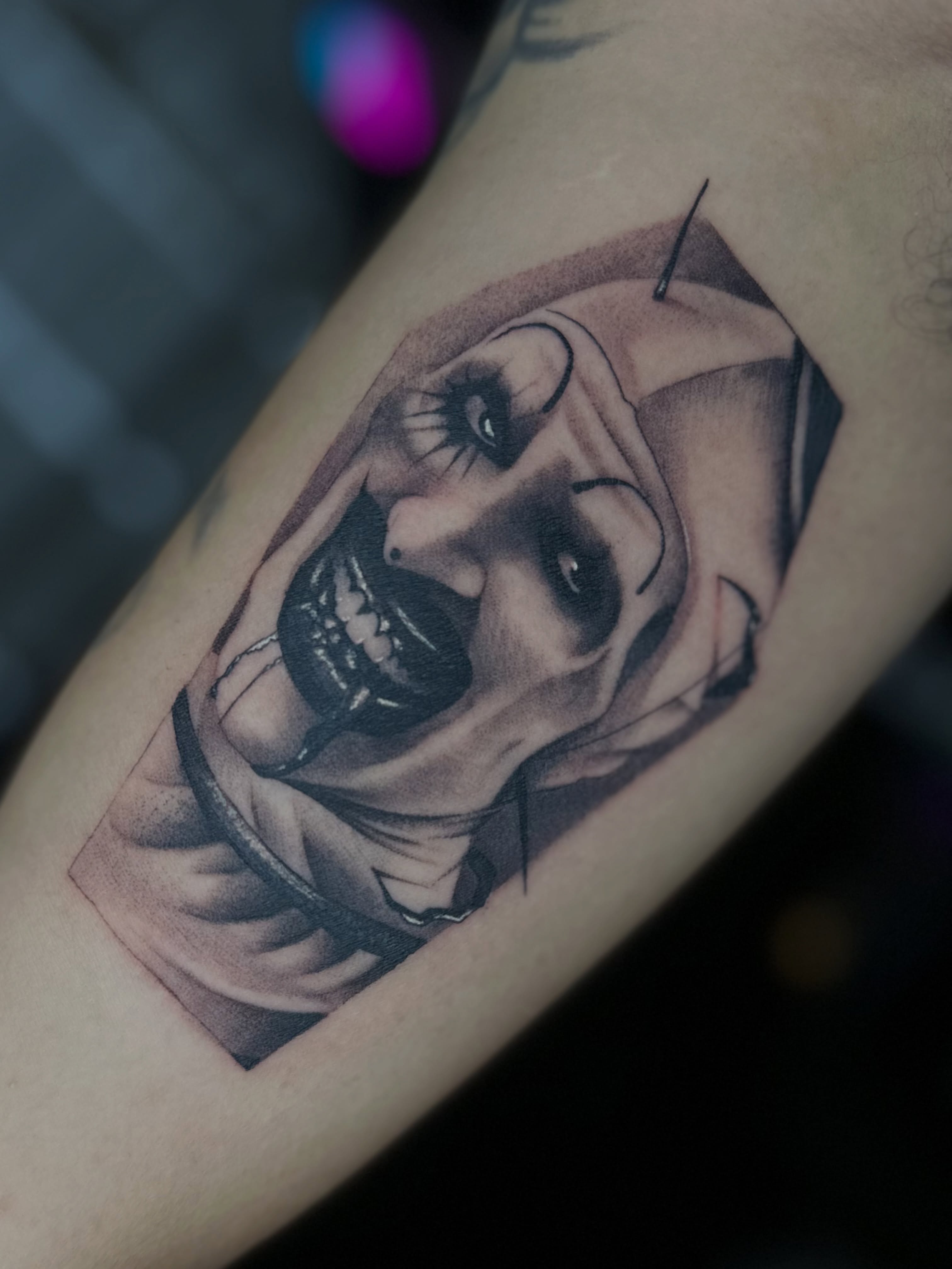 Clown realism tattoo on the forearm by @divineink_nyc