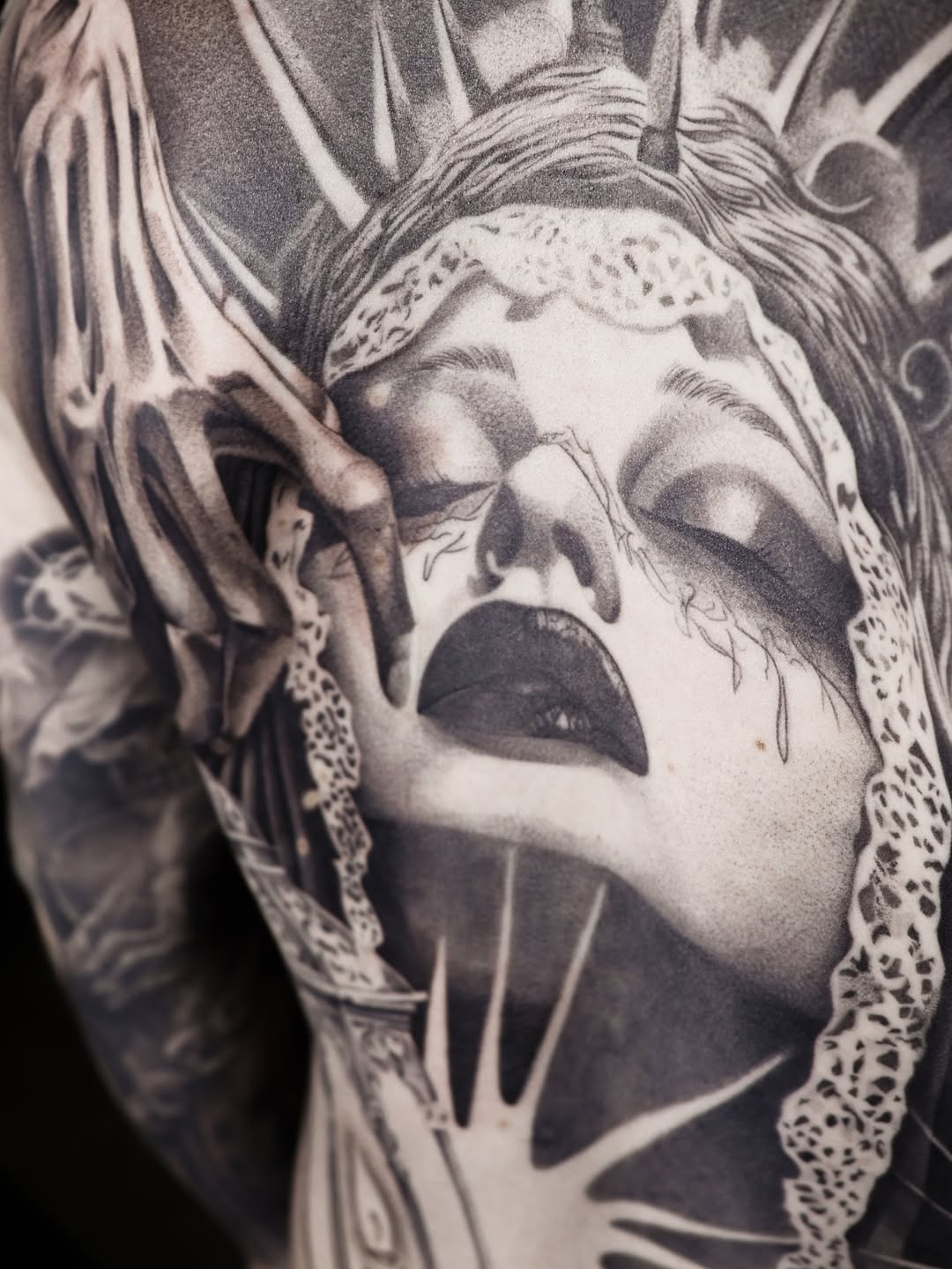 Woman's face with skeletal hand realism tattoo on the forearm by Beans