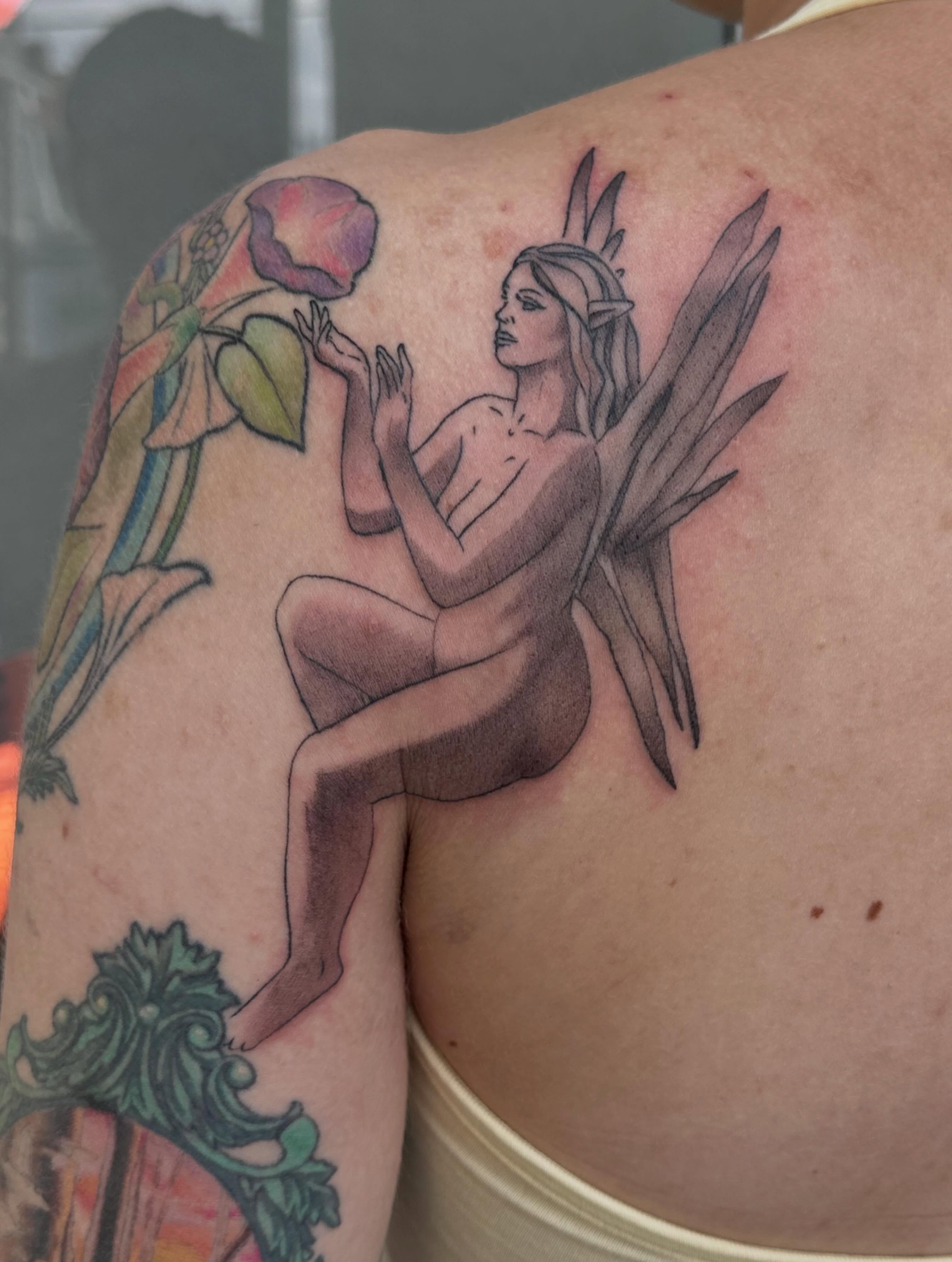 Fairy with rose realism tattoo on the shoulder by Micha Sol