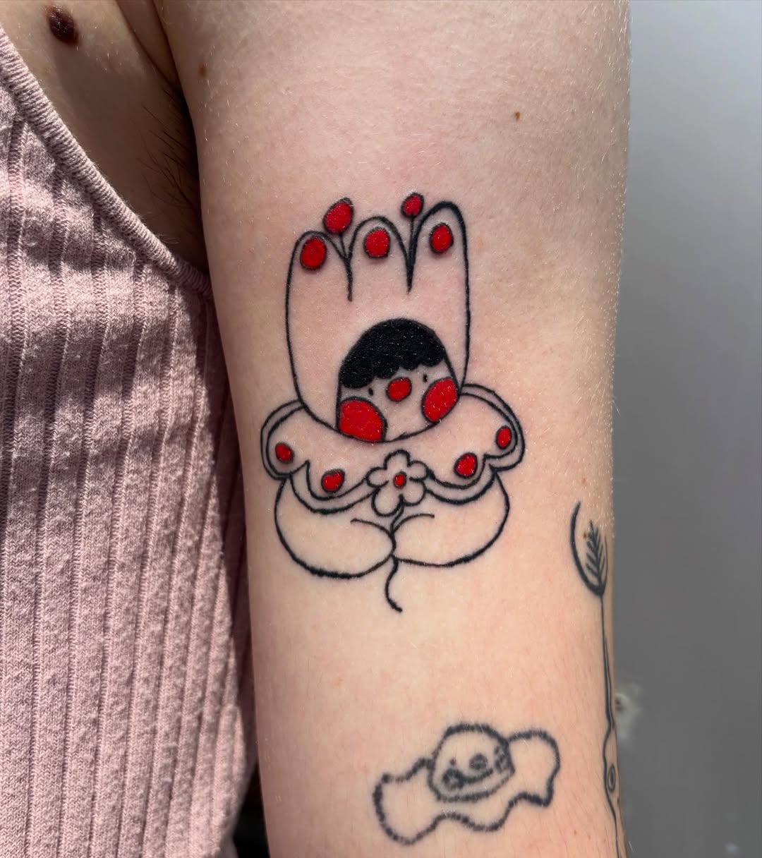 Character with flower ignorant tattoo on the forearm by riley