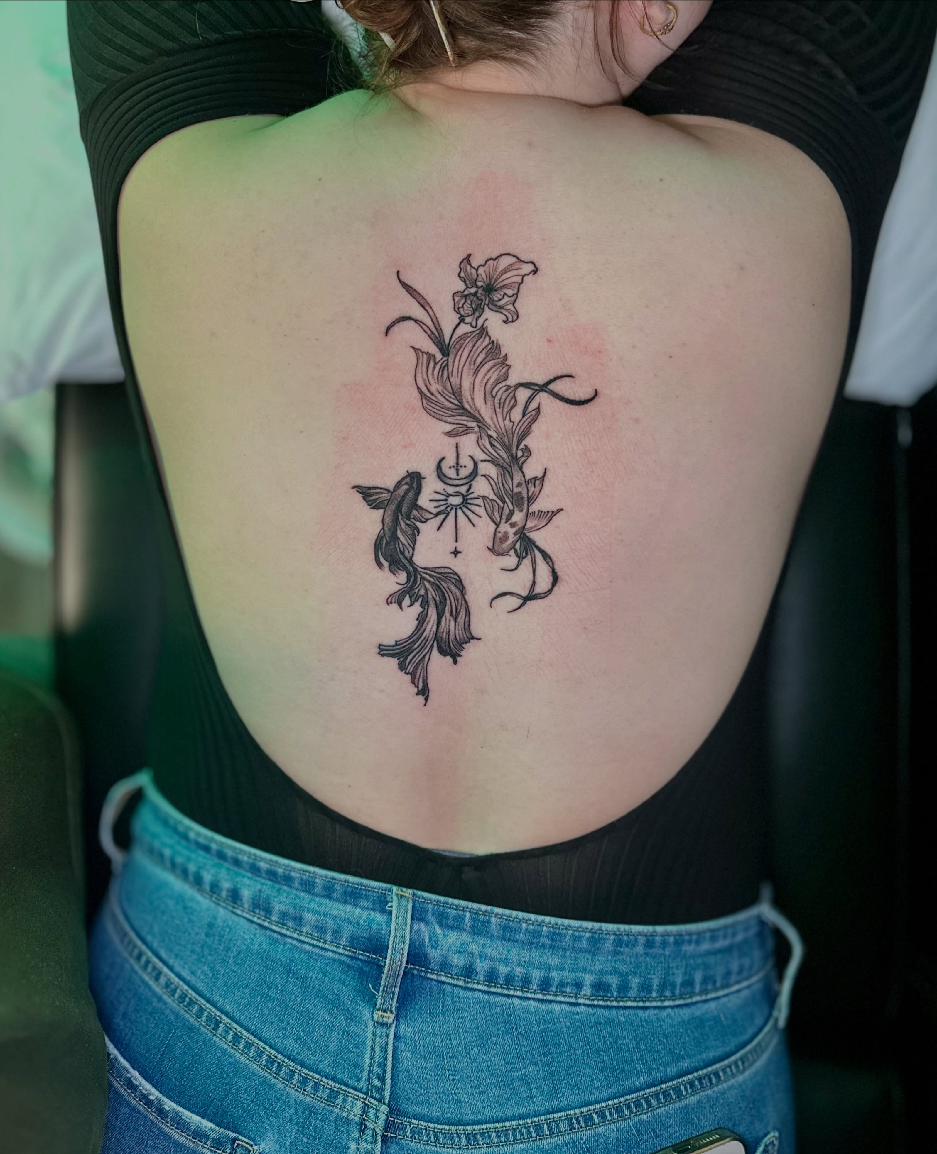 Fish and flower black and grey tattoo on the back by AJ
