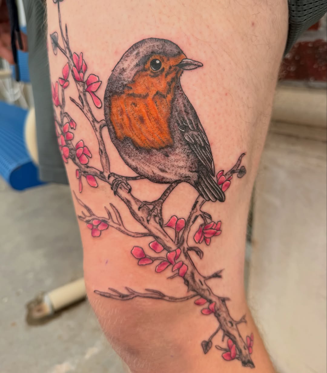 Bird and blossoms realism tattoo on the forearm by Lexi Odam