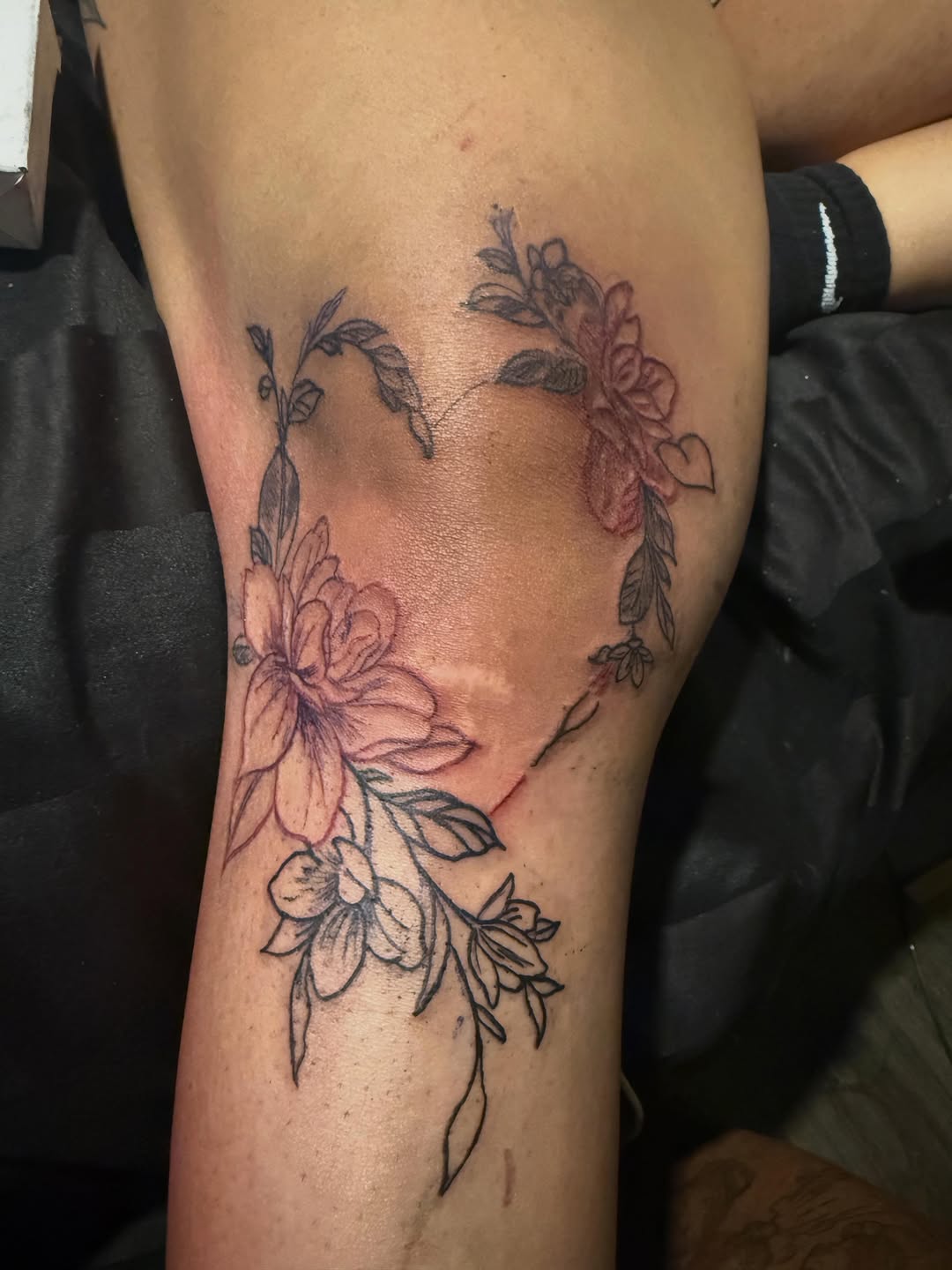 Floral heart outline fine line tattoo on the forearm by Tatz By Benji