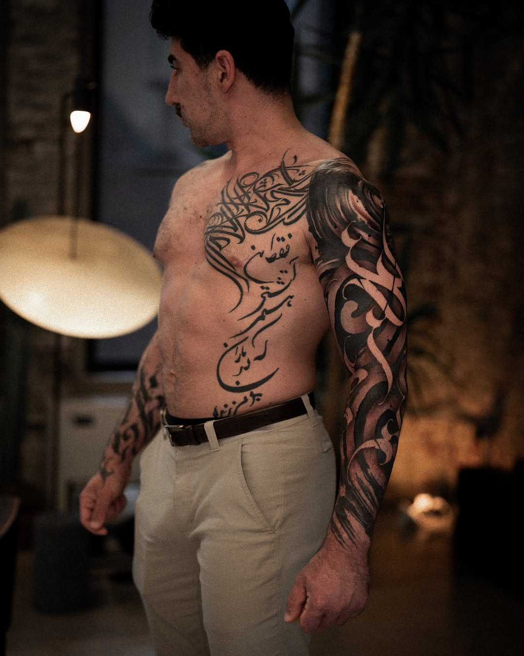 Arabic calligraphy blackwork tattoo on the torso by Low, Brooklyn, New York