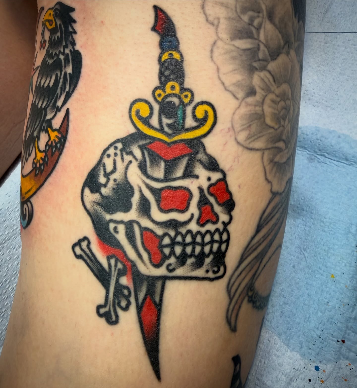 Skull with dagger American traditional tattoo on the forearm by Chuck Paprocki, Nashville, Tennessee