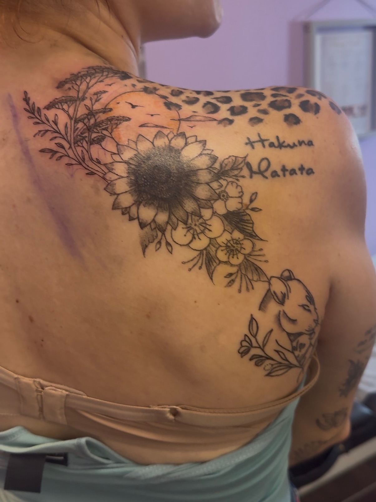 Sunflower and leopard print black and grey tattoo on the shoulder by Jay
