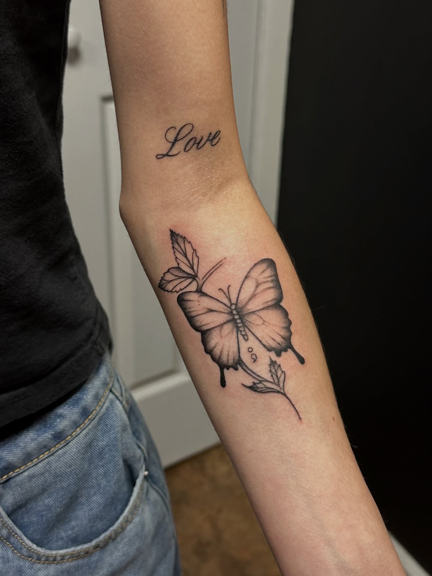 Butterfly black and grey tattoo on the forearm by Jocelyn